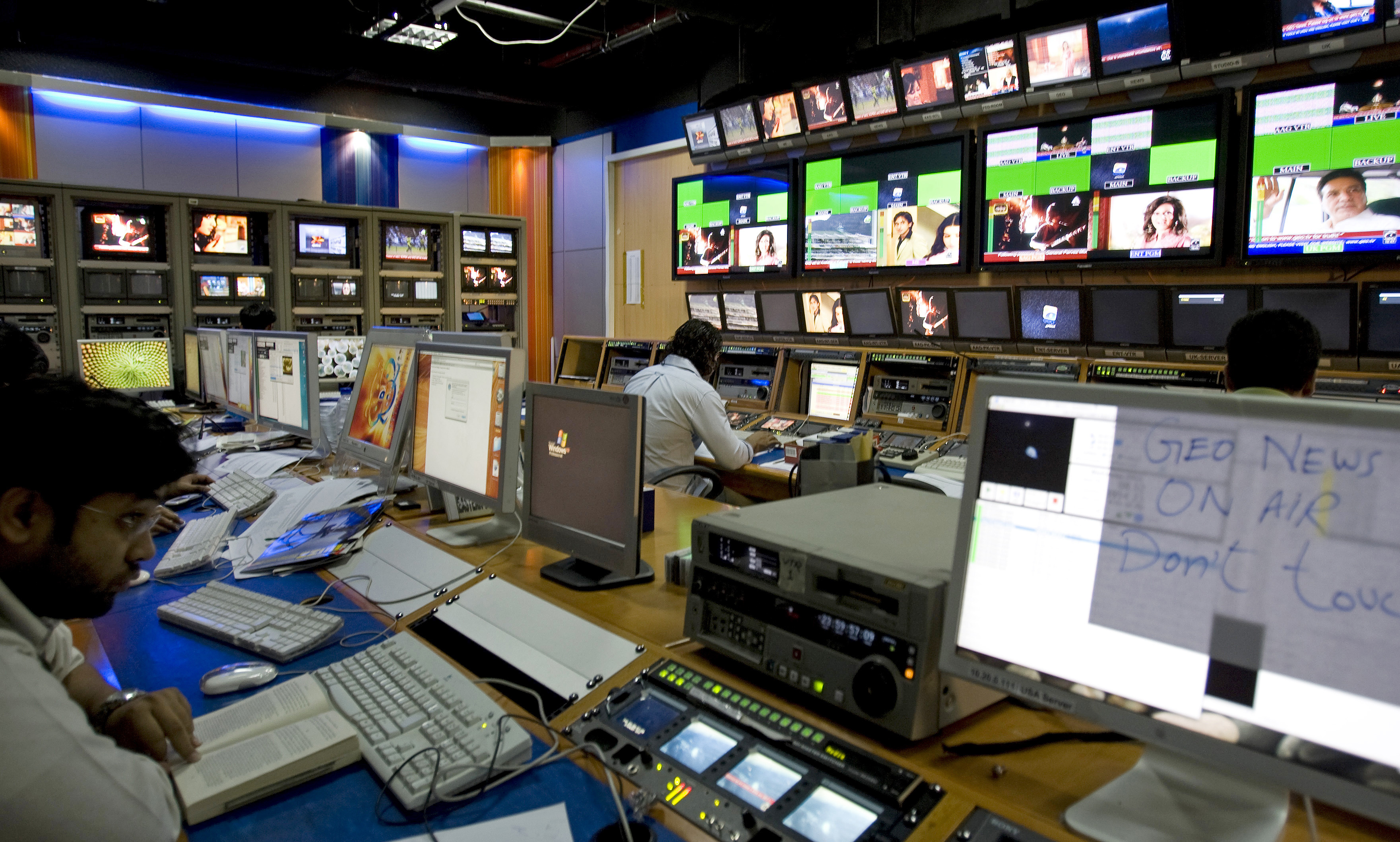 TV producers work at a control room of Geo News