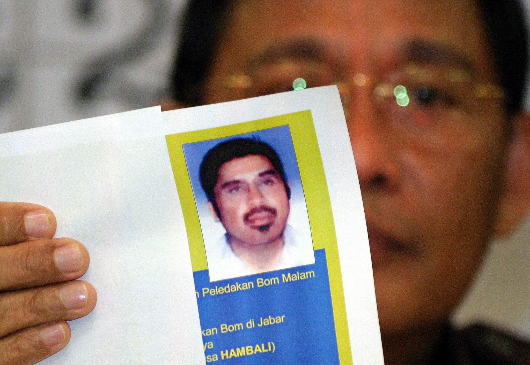 Indonesia's top detective holds a photo of Hambali at a press conference in 2003