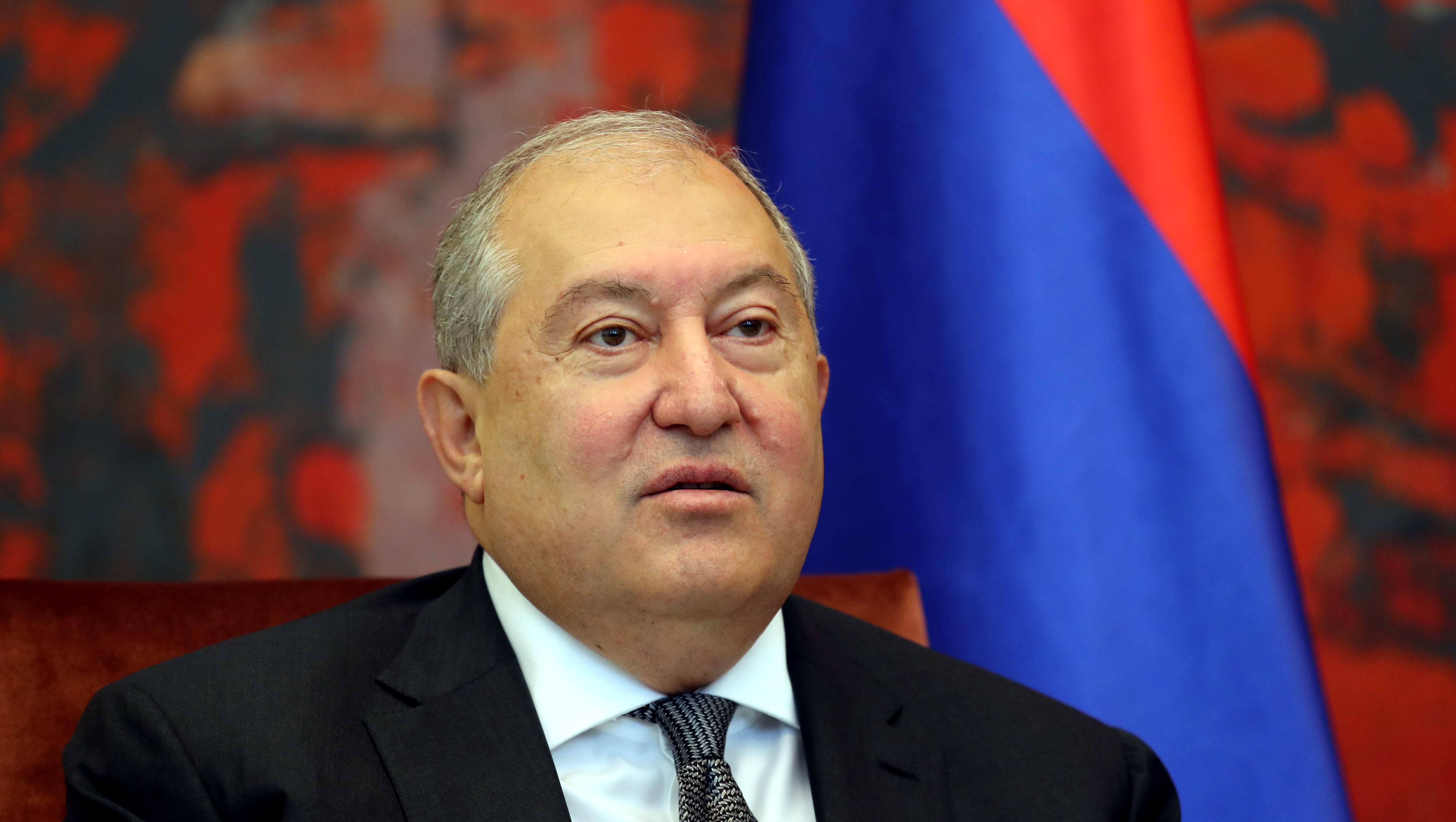 Armenian President Armen Sarkissian looks on
