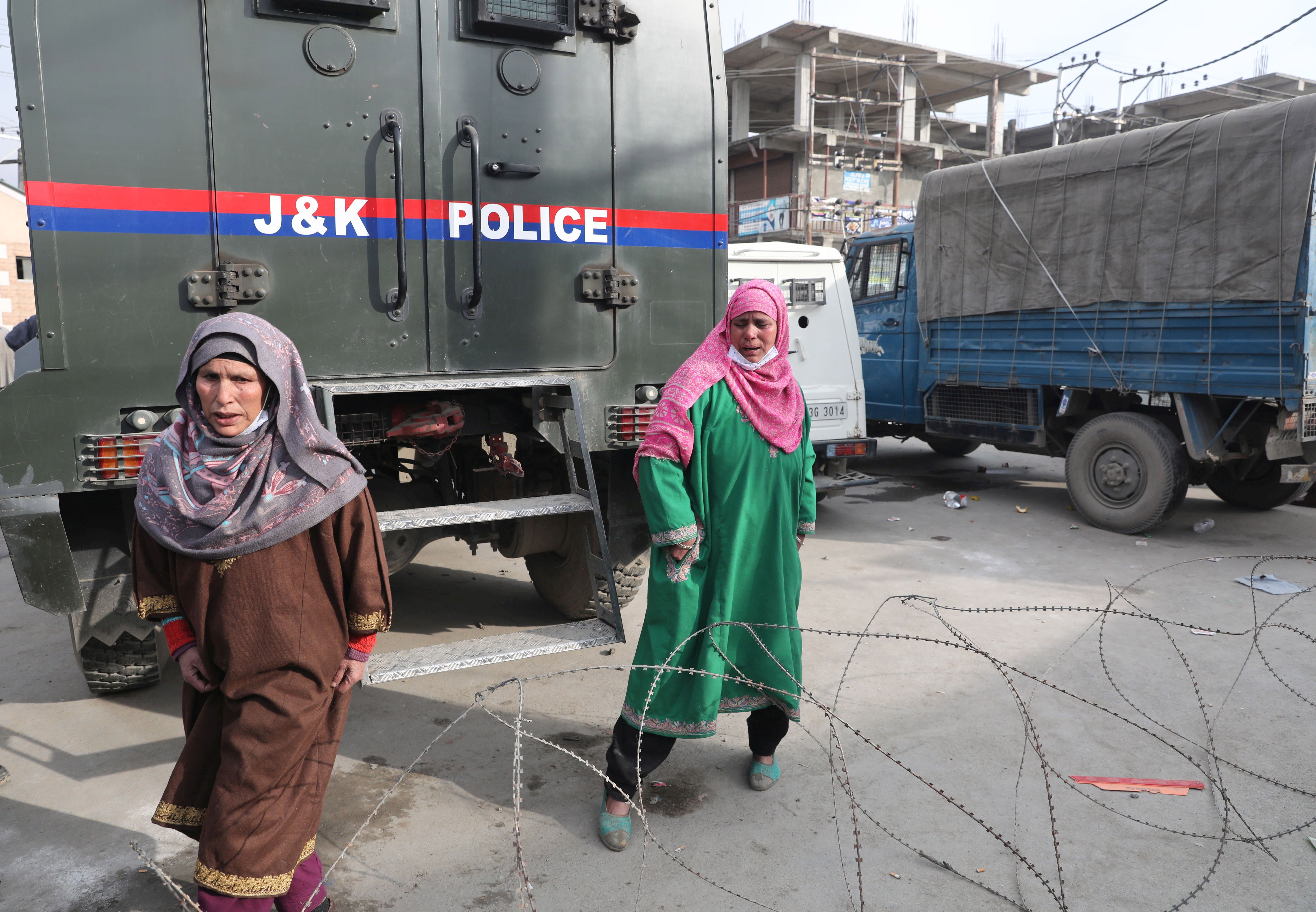 Relative of slain militants walk outside Police Control Room in Srinagar