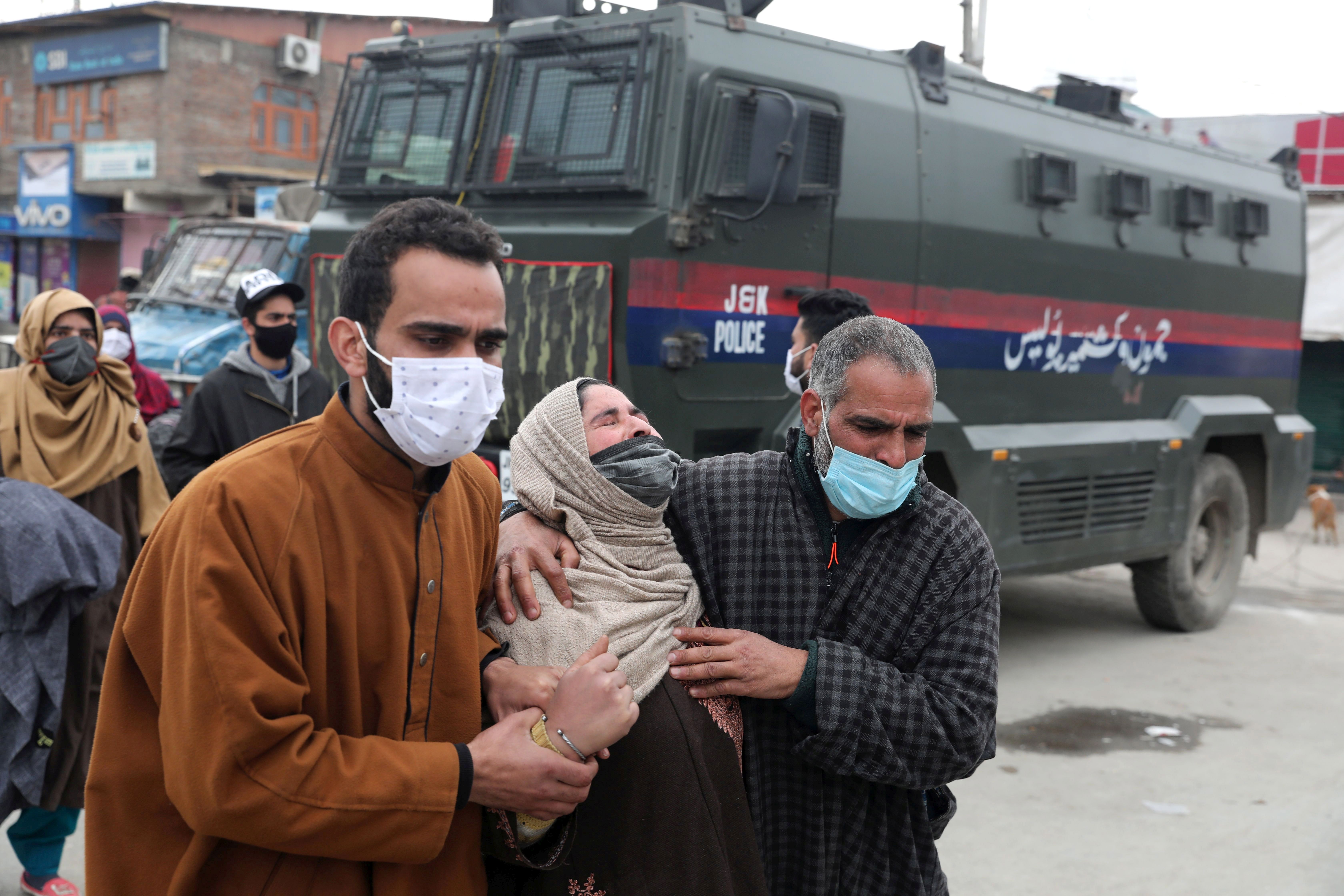 People console a relative of slain militants outside Police Control Room in Srinagar