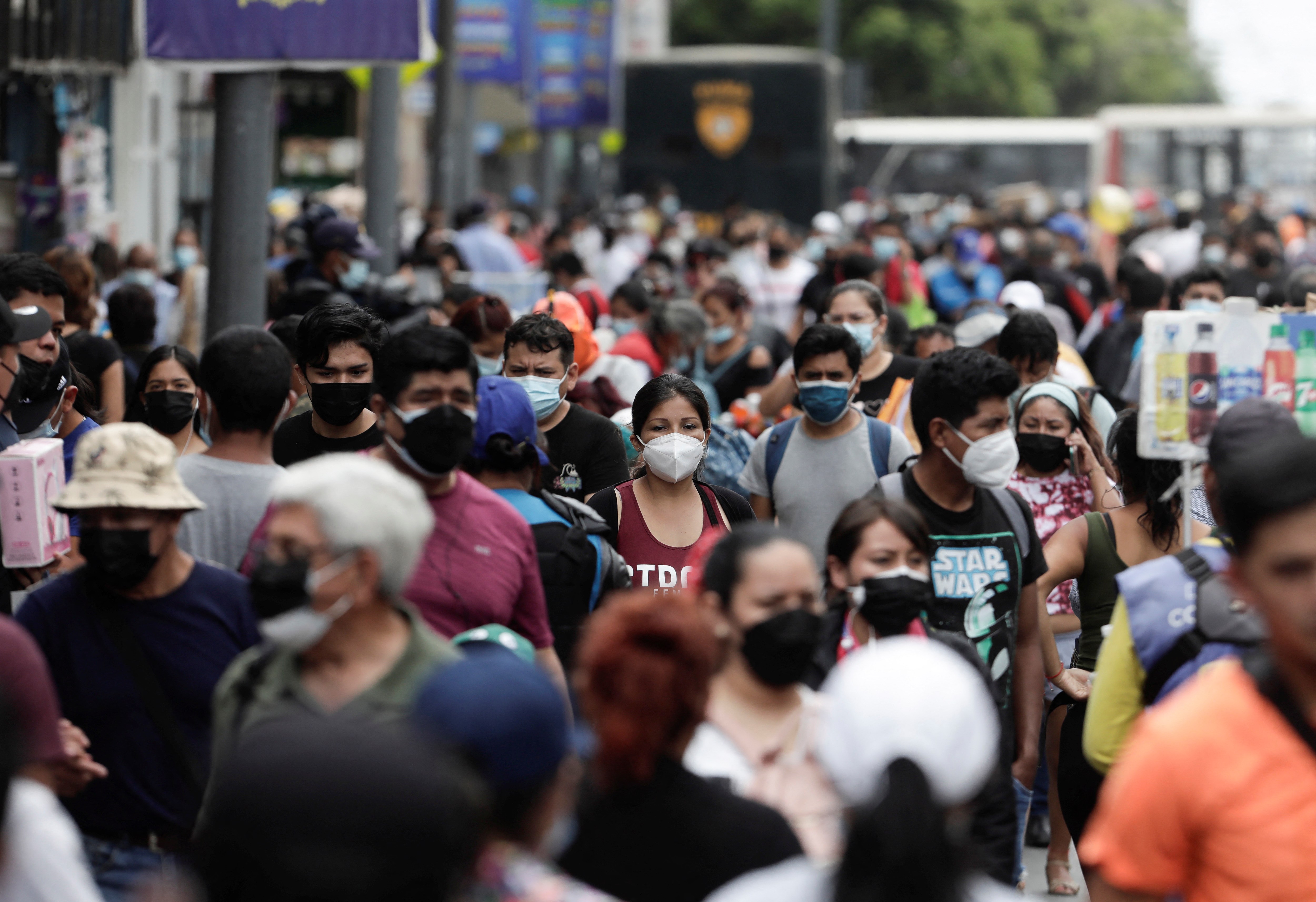 People walk in a crowded street as new cases of the coronavirus disease (COVID-19), driven by the Omicron variant, are surging, in Lima, Peru