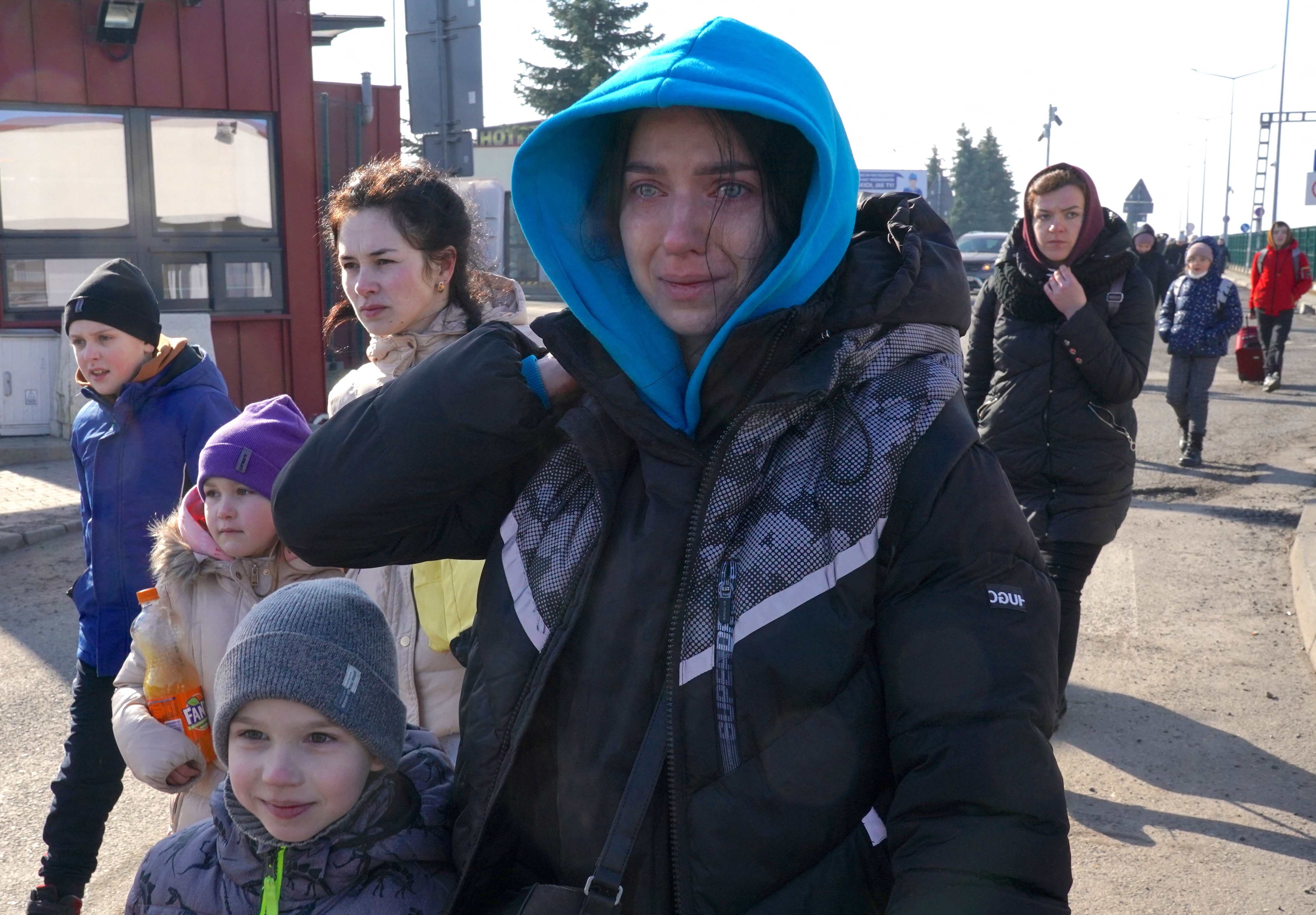 Ukrainian women and children cross the border from Ukraine to Poland