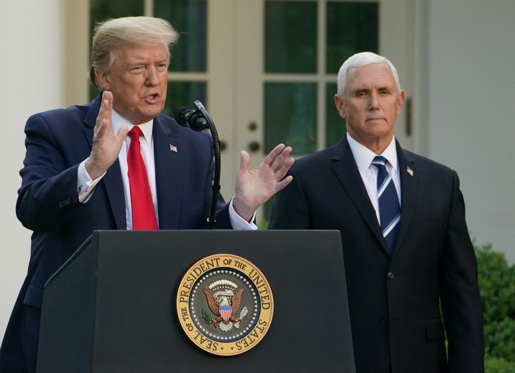 Former US President Donald Trump speaks as former US Vice President Mike Pence looks on during a news conference in the Rose Garden of the White House in Washington, DC