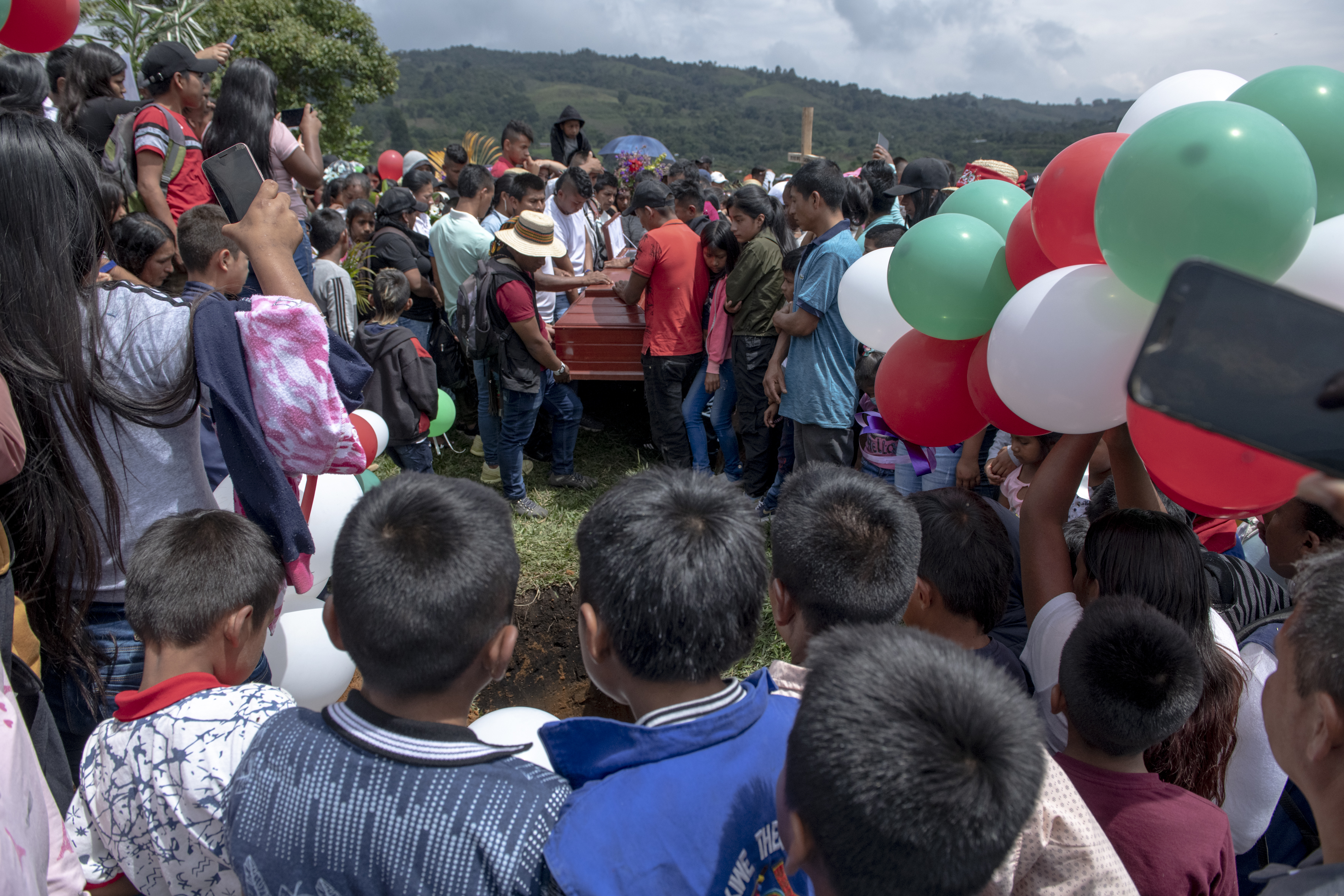 Young boys observe the upcoming burial of the casket containing the body of Breiner David.