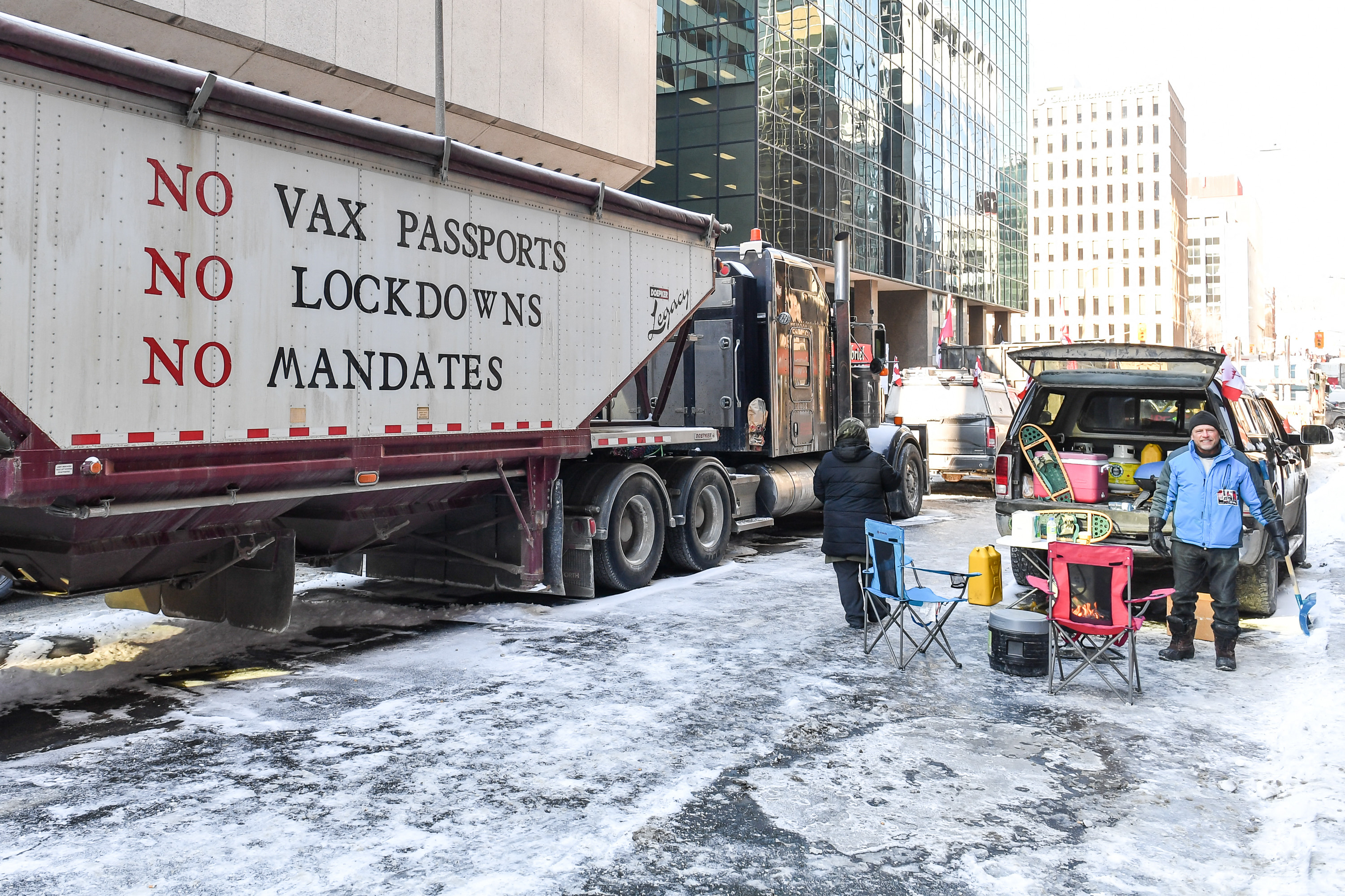 A truck parked on a street with a message condemning imposed COVID mandates