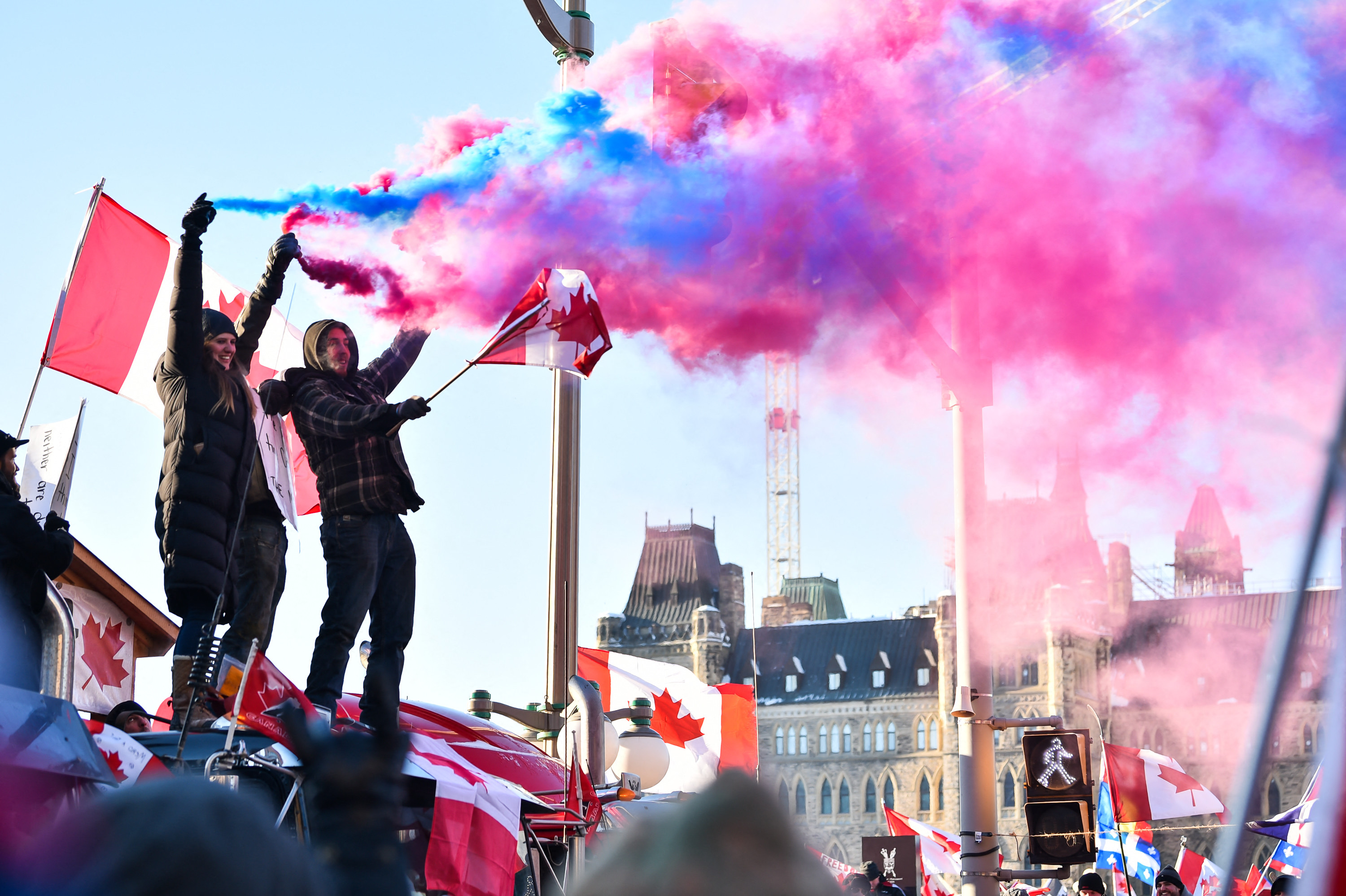 Protesters release smoke flares in front of Parliament in Ottawa, Canada.