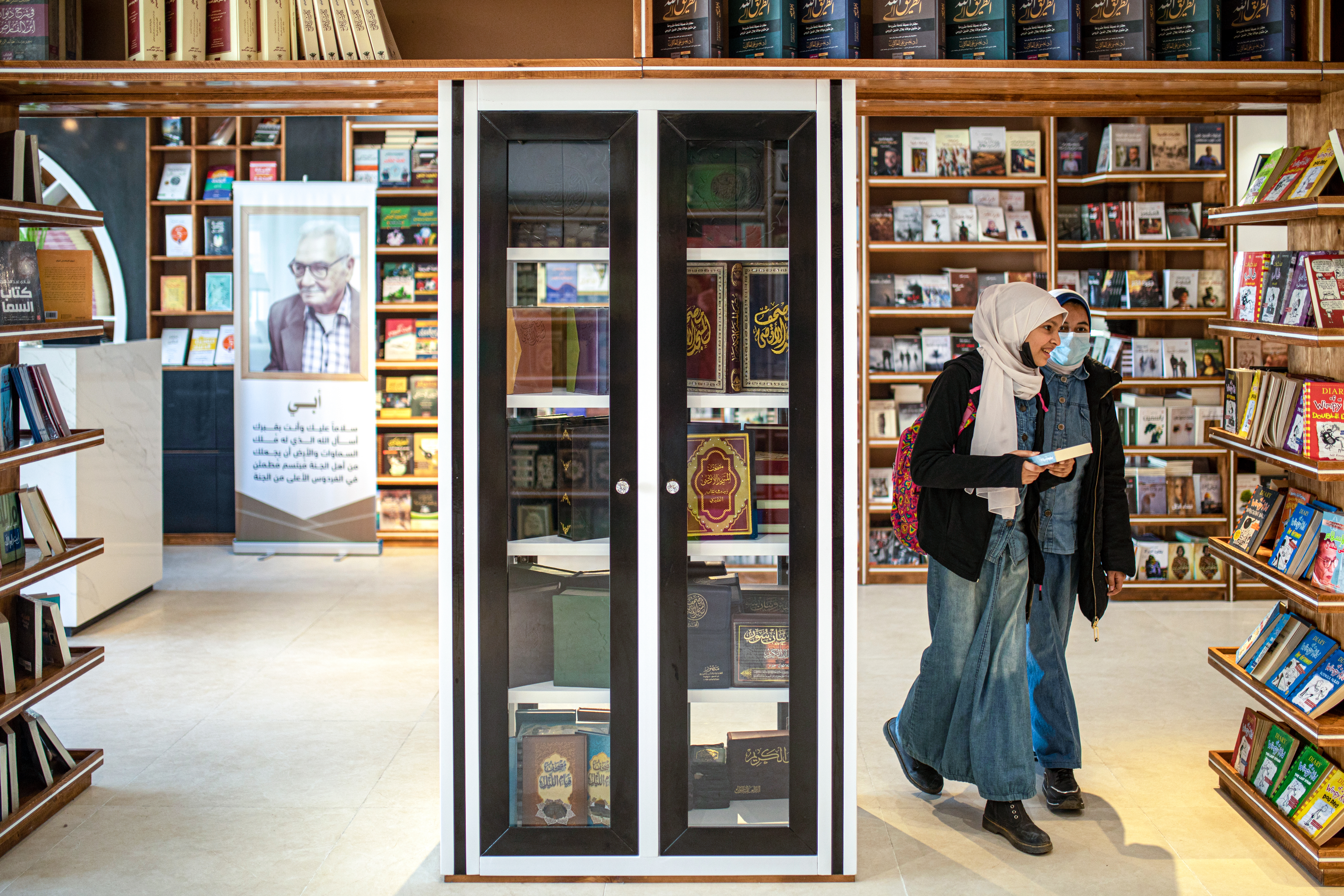 Girls browse for books in a bookstore