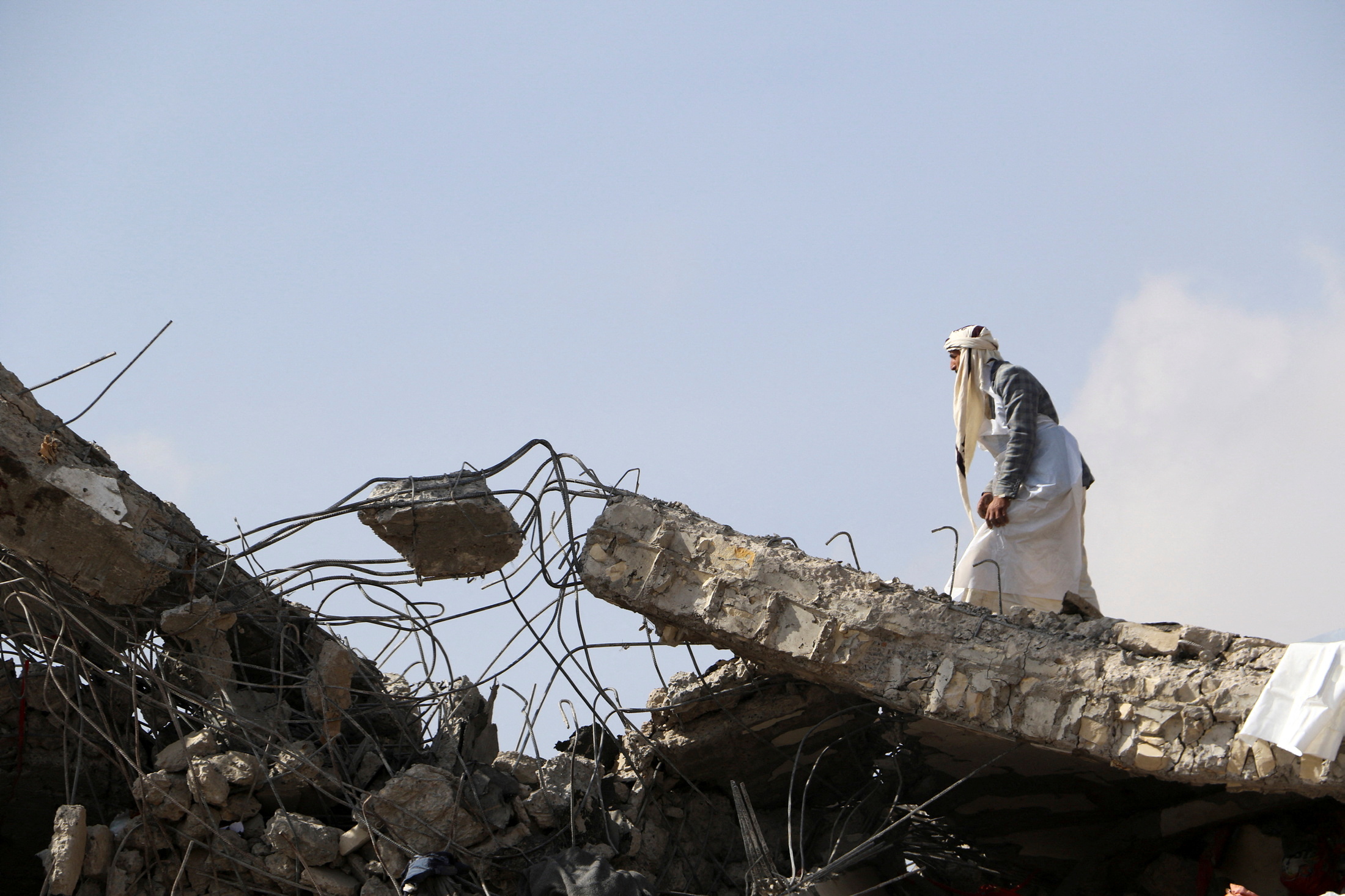 A man walks on the collapsed roof