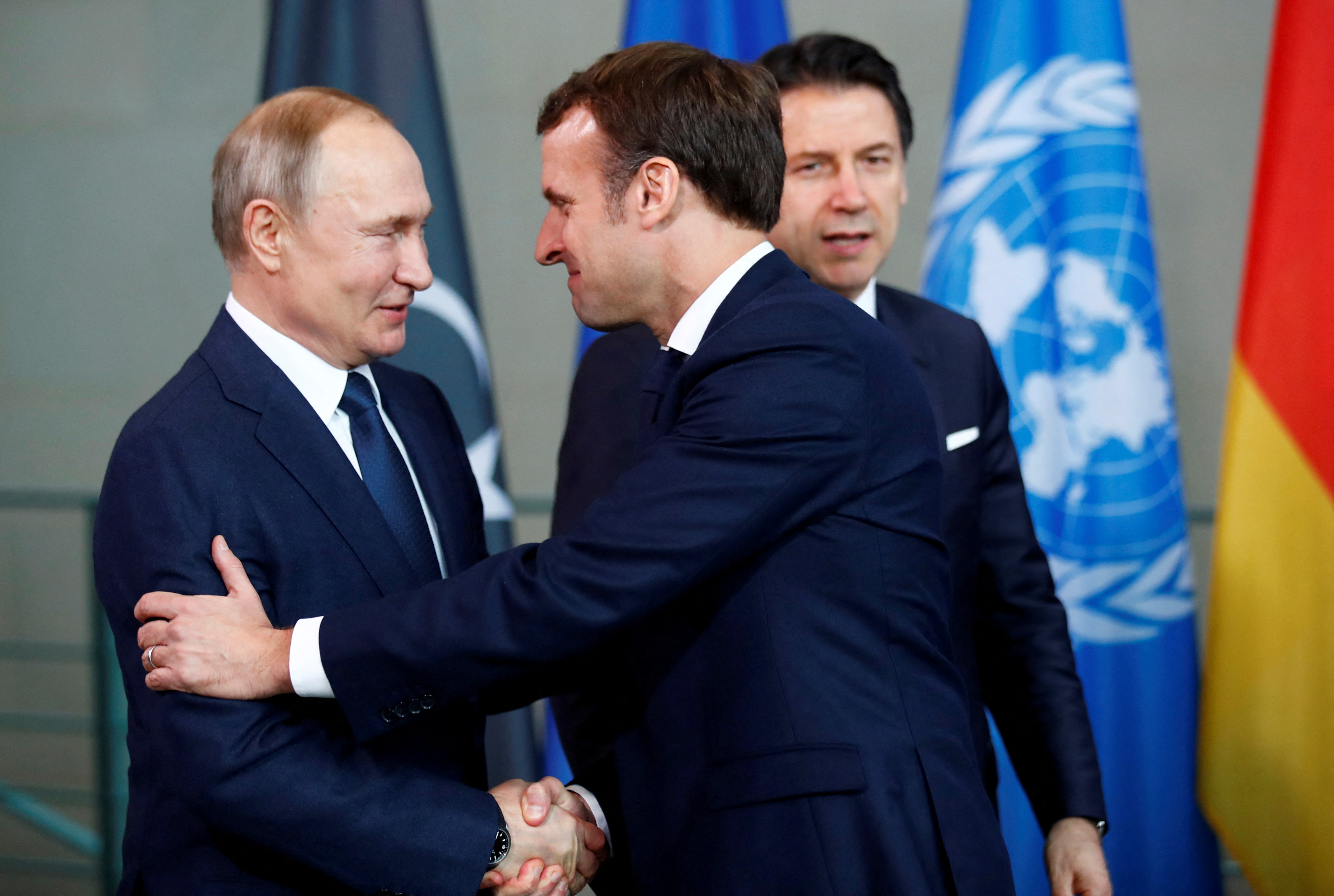 Russian President Vladimir Putin shakes hands with French President Emmanuel Macron in Berlin, Germany, January 19, 2020.