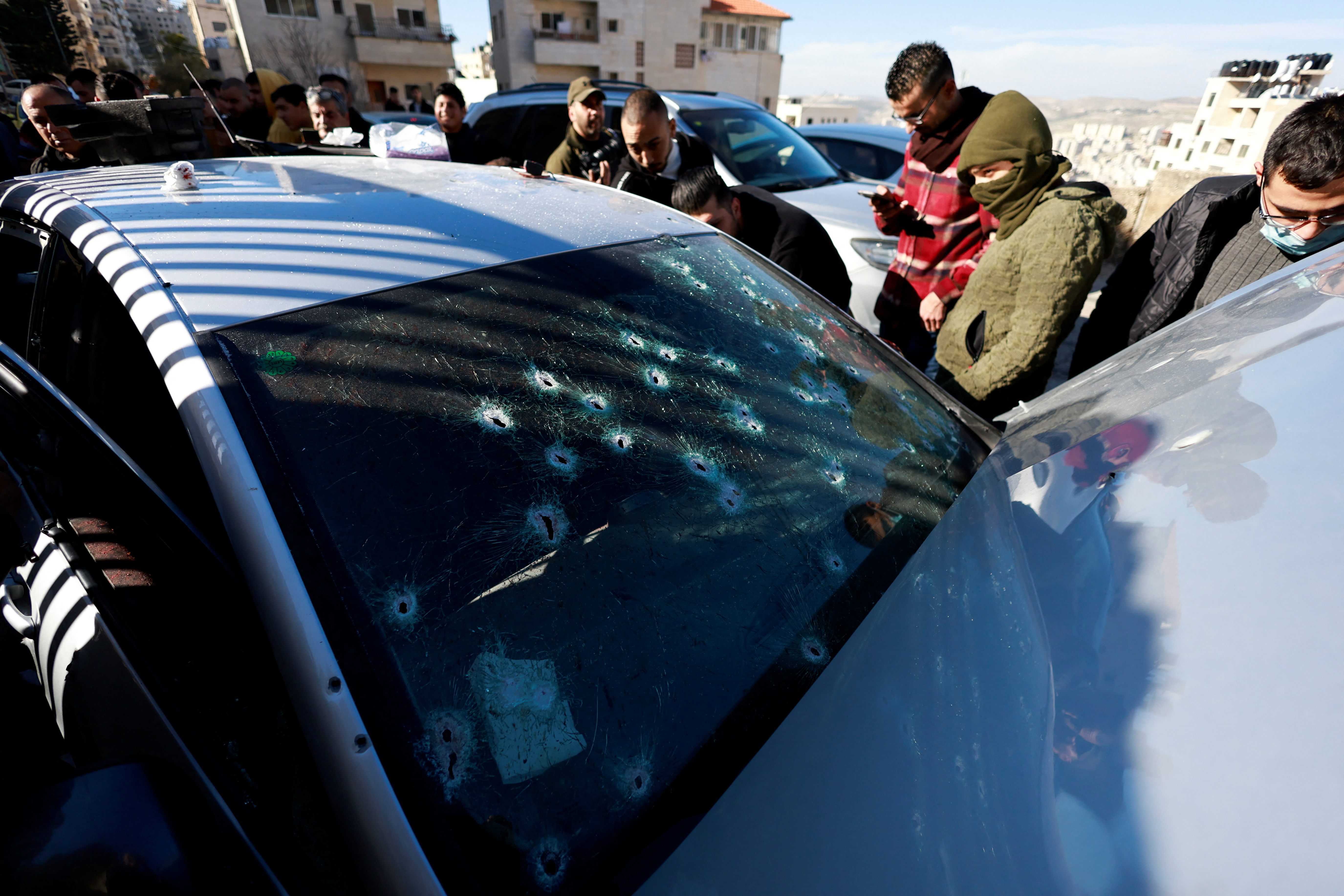 People inspect the scene where three Palestinian gunmen were killed by Israeli forces, in Nablus in the Israeli-occupied West Bank