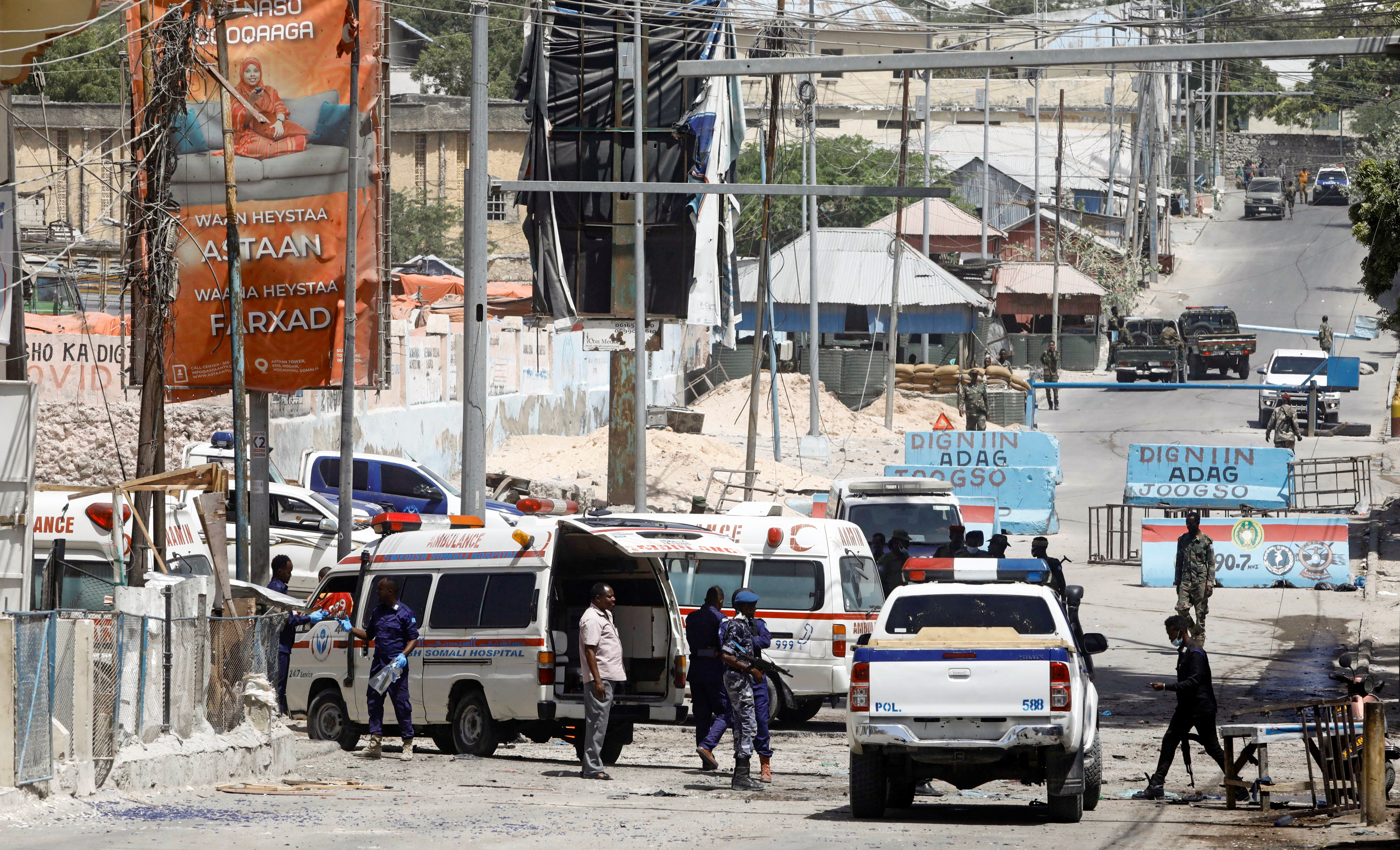 Somali security forces secure the road leading to the scene of an explosion at a checkpoint near the presidential palace in Mogadishu, Somalia
