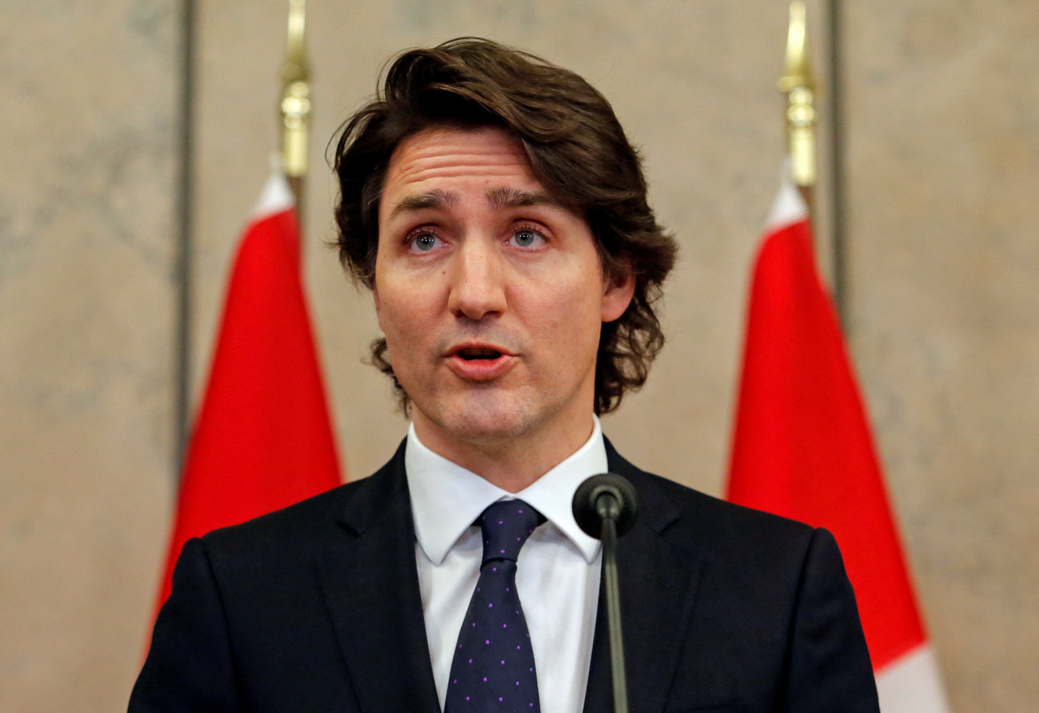 Canadian PM Justin Trudeau speaks at a podium