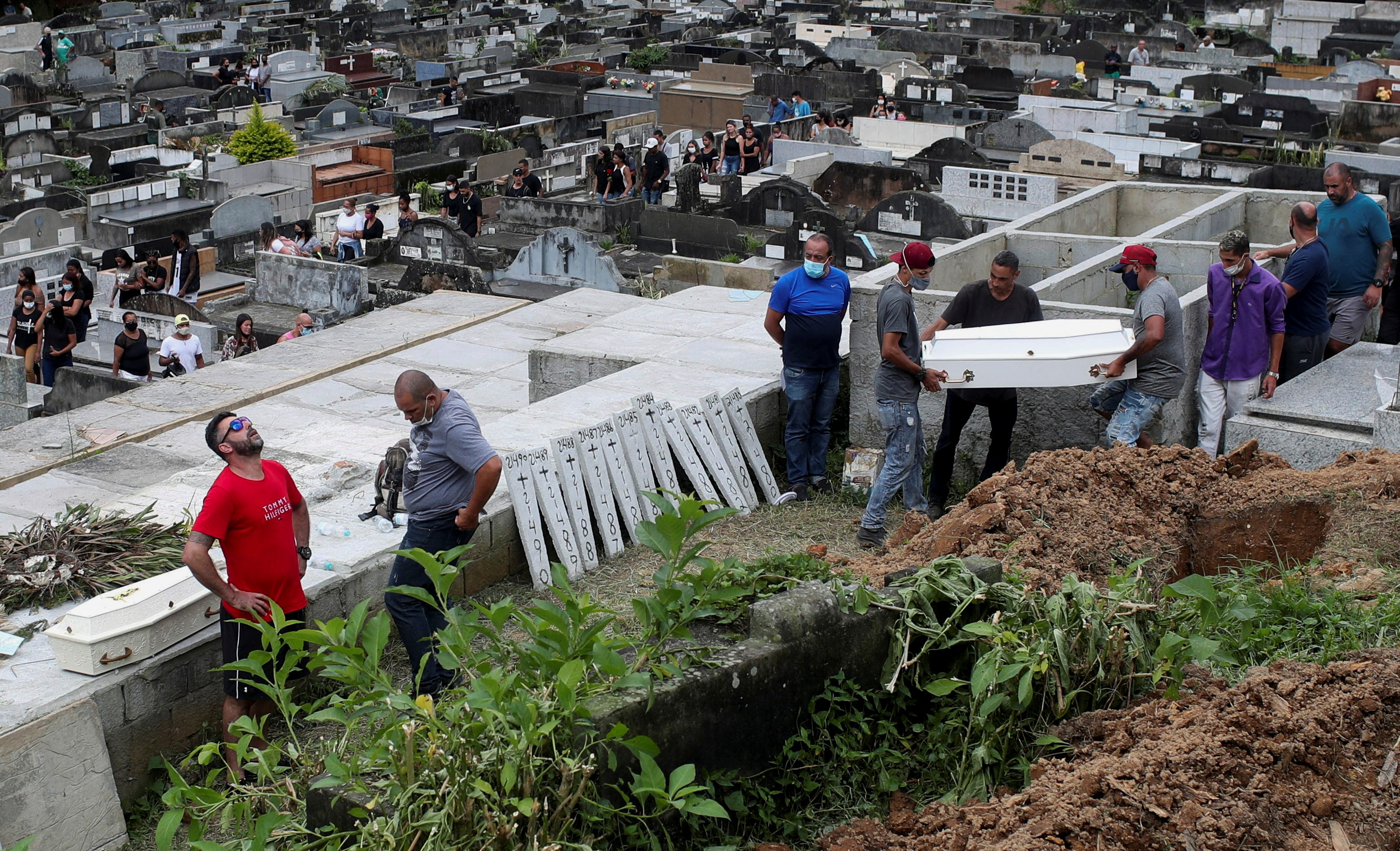 Relatives burying victims