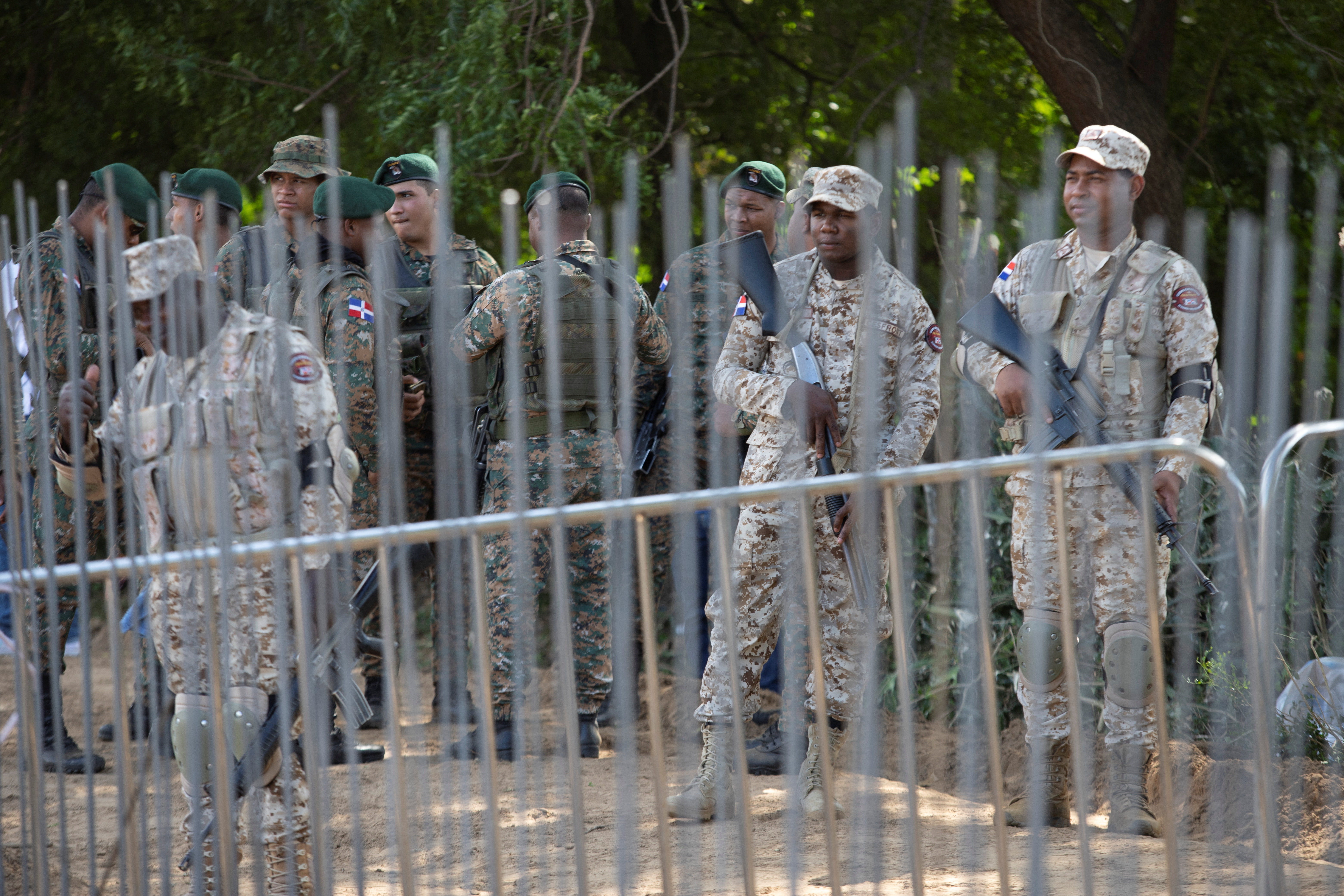 Soldiers guarding border wall construction