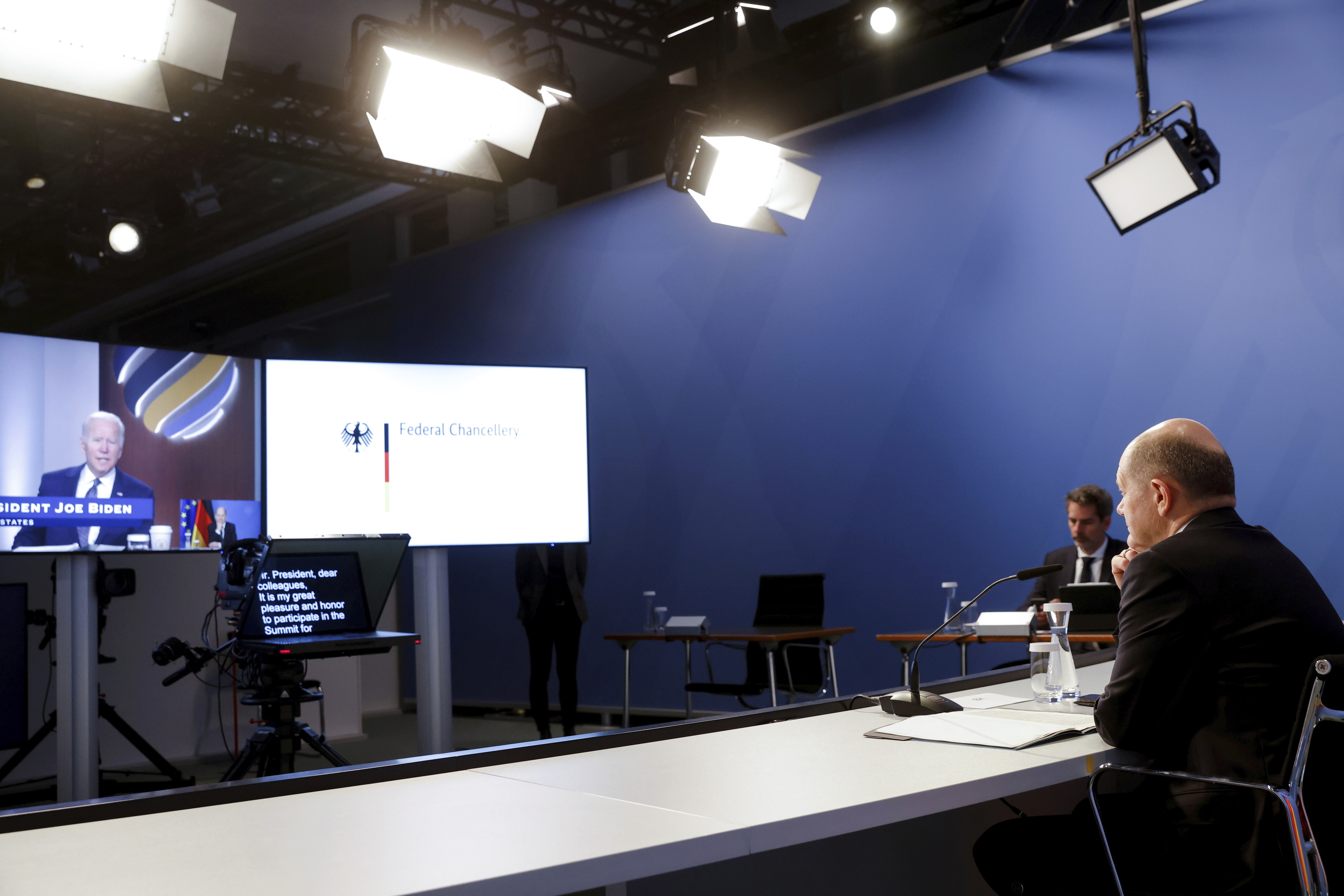 German Chancellor Olaf Scholz listens to opening remarks from U.S. President Joe Biden at the start of the virtual Summit for Democracy, at the Chancellery in Berlin, Germany, Thursday, Dec. 9, 2021.