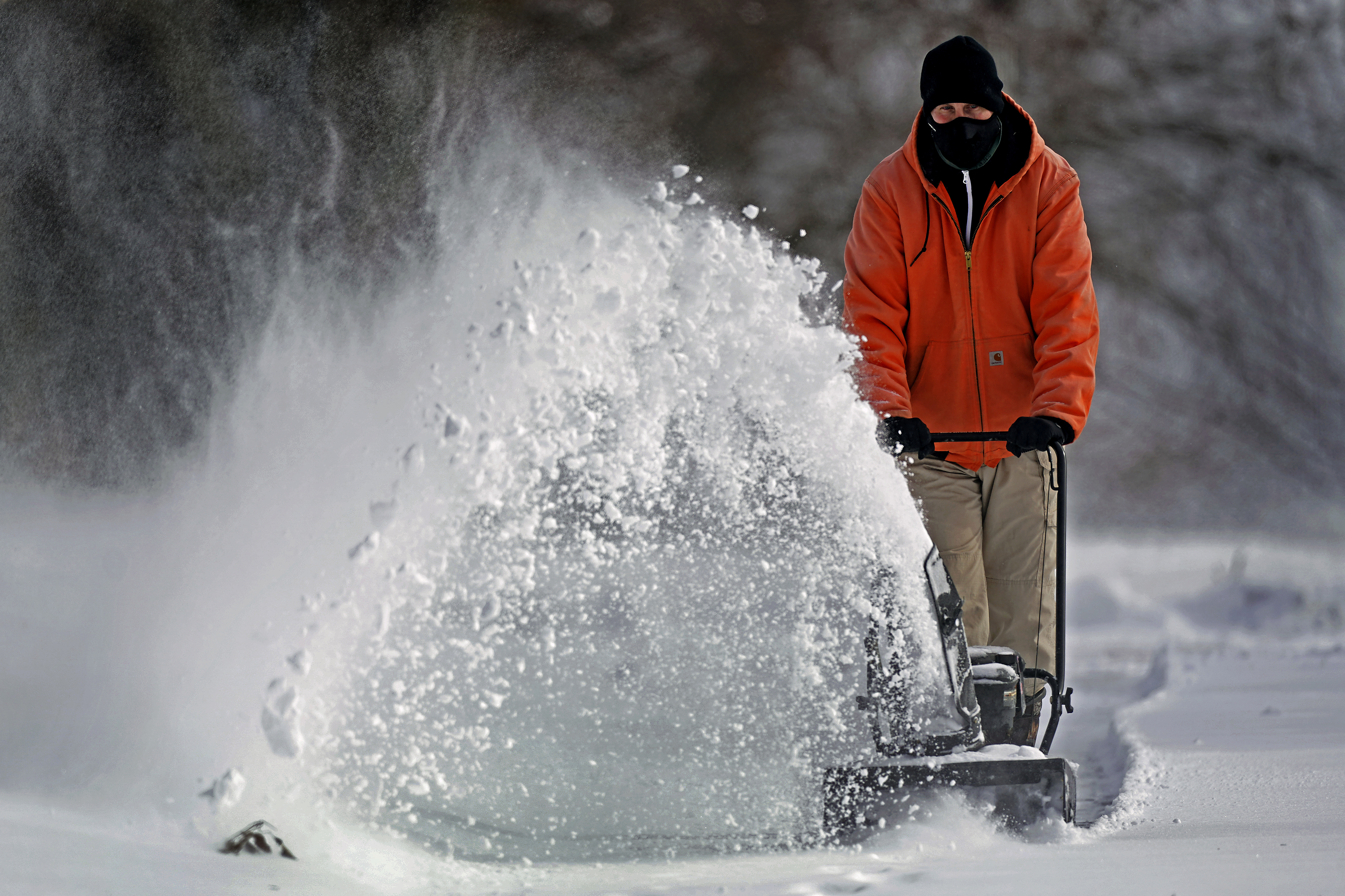 John Tapko clears snow at his house