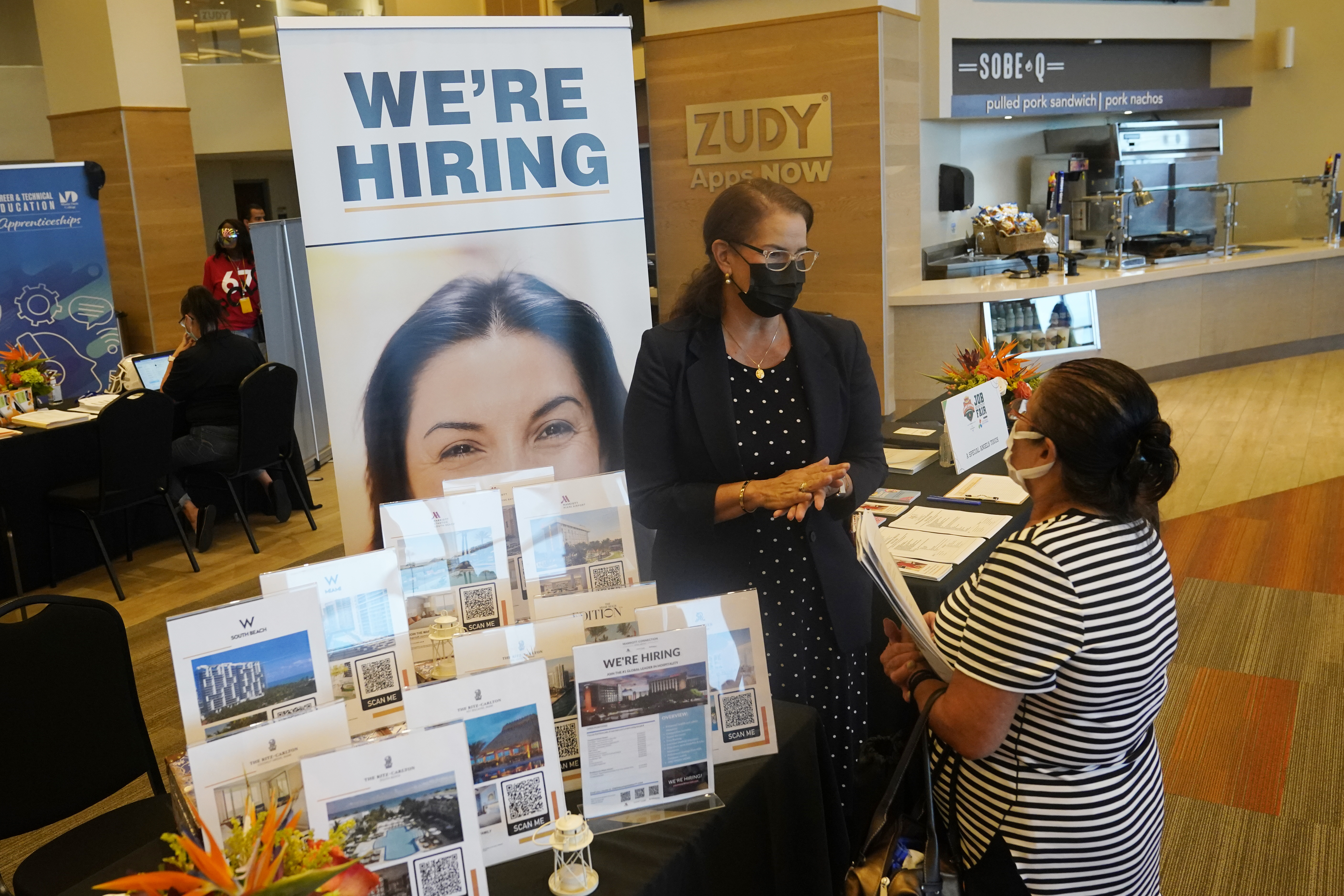Marriott human resources recruiter Mariela Cuevas, left, talks to Lisbet Oliveros, during a job fair at Hard Rock Stadium, Friday, Sept. 3, 2021, in Miami Gardens, Florida.