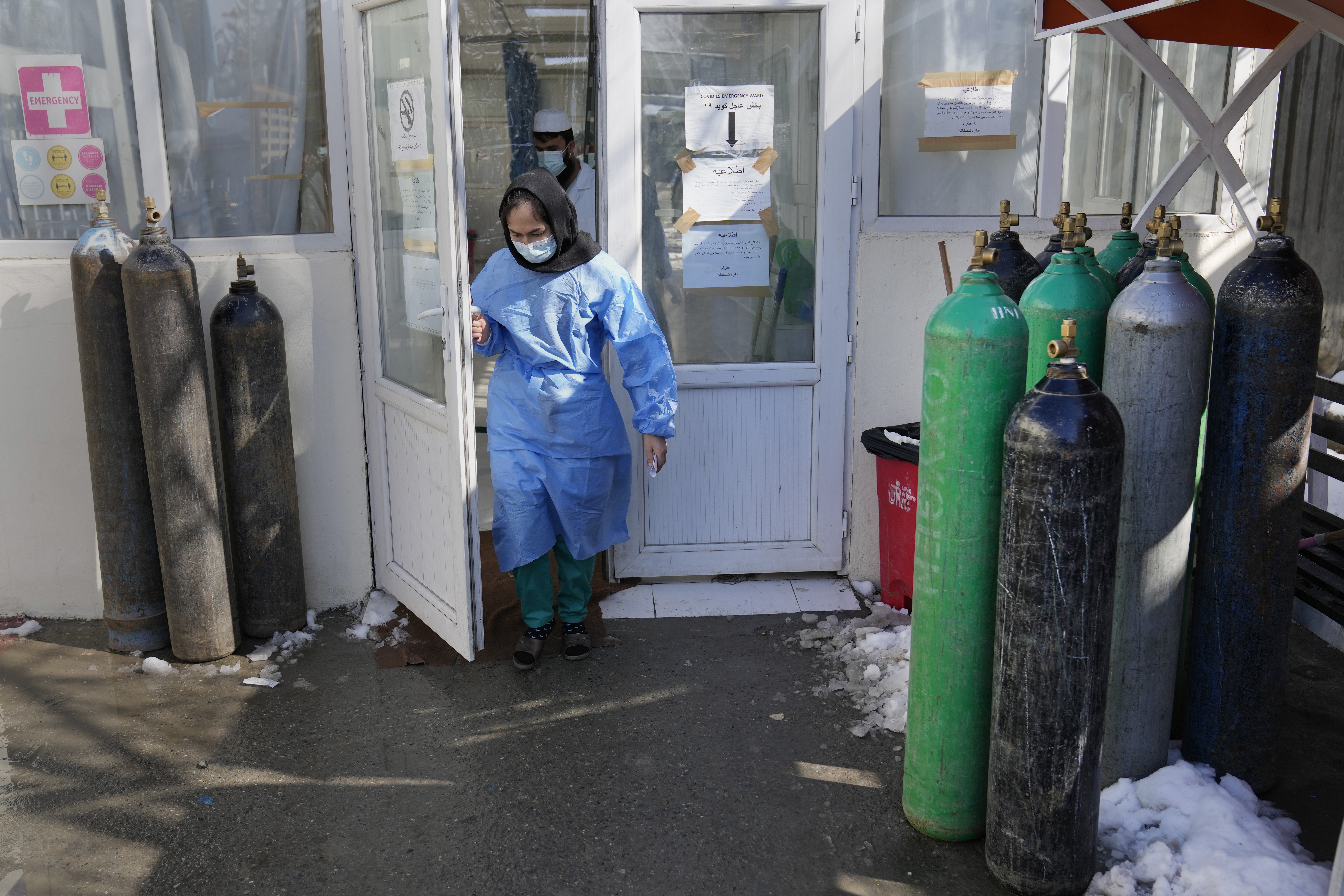 A nurse exits the COVID-19 intensive care unit of the Afghan Japan Communicable Disease Hospital
