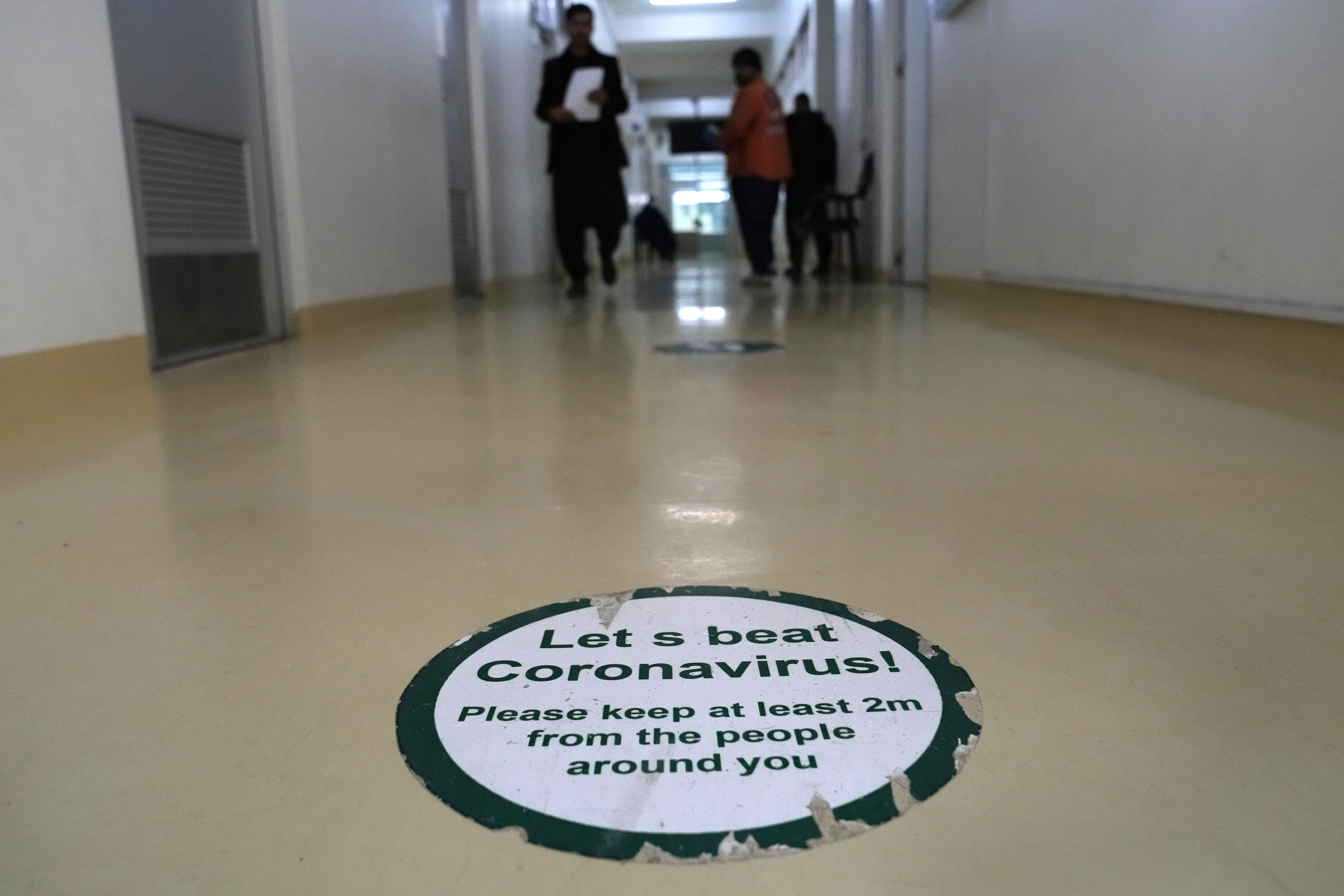 A sticker displays COVID-19, guidelines in a corridor of the COVID-19 intensive care unit