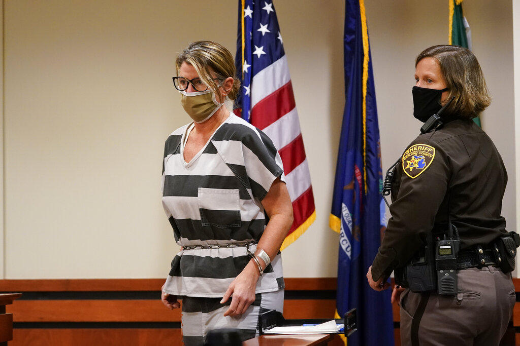 ennifer Crumbley, mother of Ethan Crumbley, a teenager accused of killing four students in a shooting at Oxford High School, dressed in black and white stripped prison garb arrives in court for a preliminary examination on involuntary manslaughter charges.