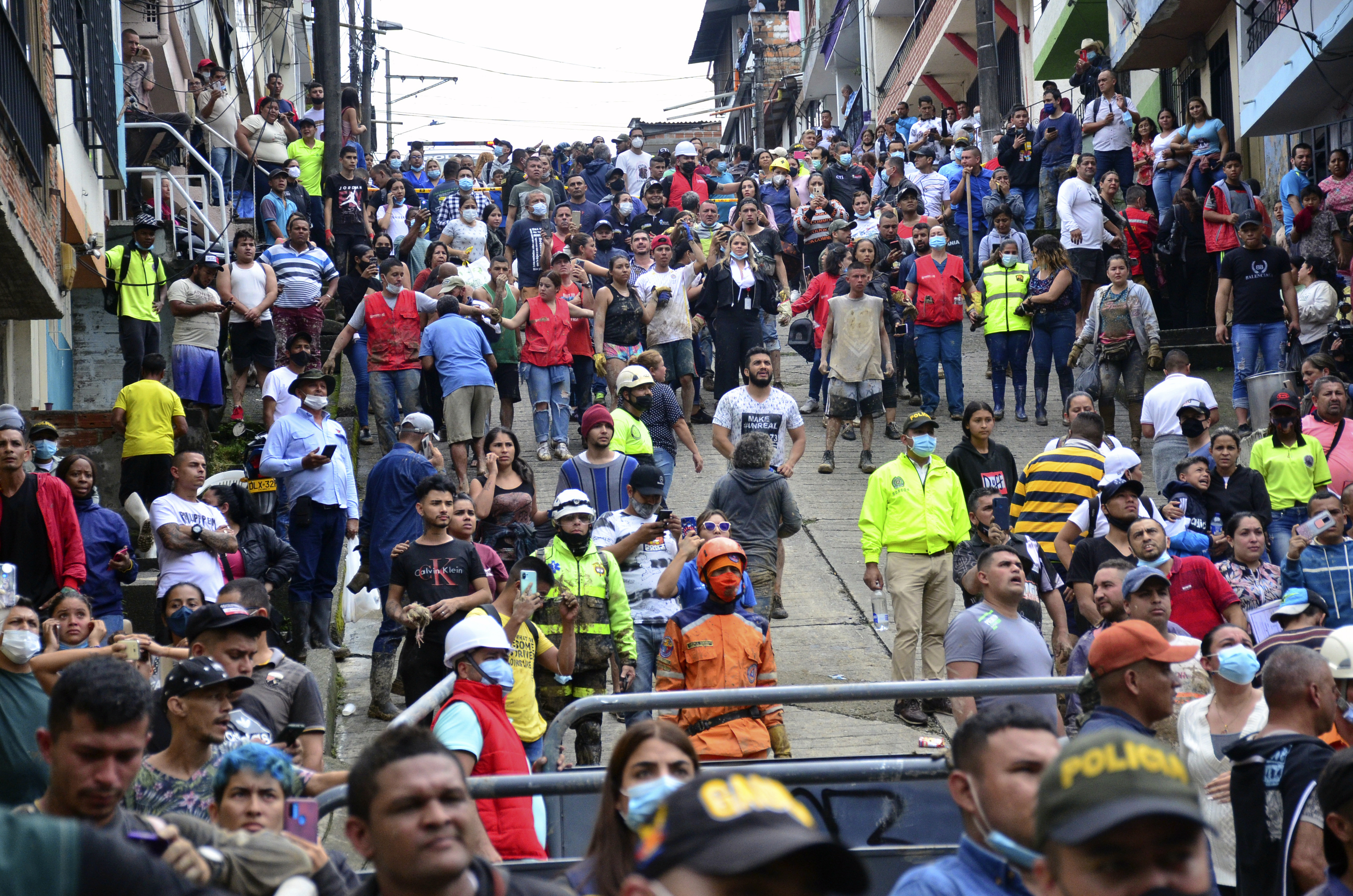 Evacuated residents watch the rescue operation