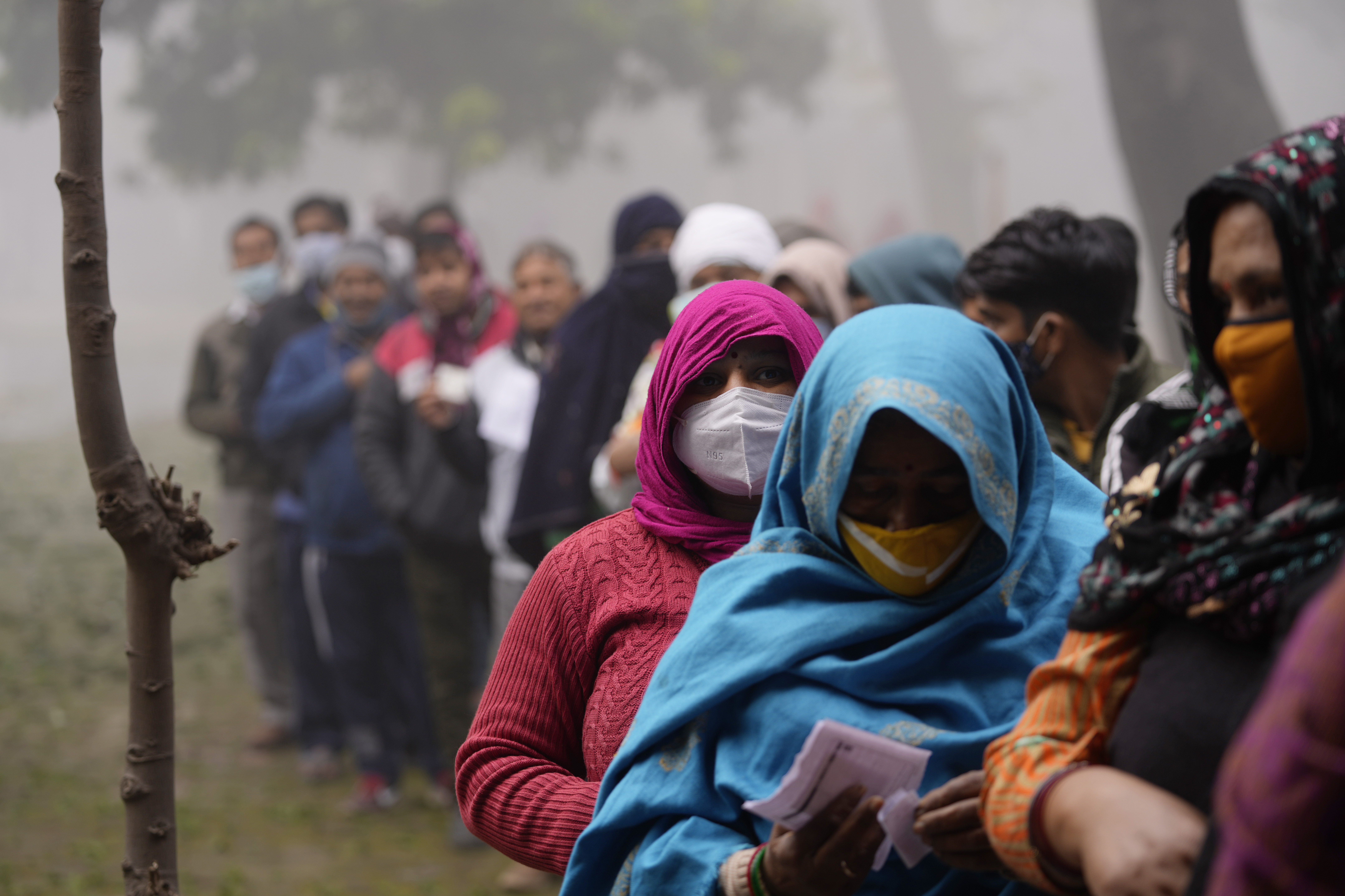 People line up to vote during the first phase of Uttar Pradesh state elections at Village near Ghaziabad