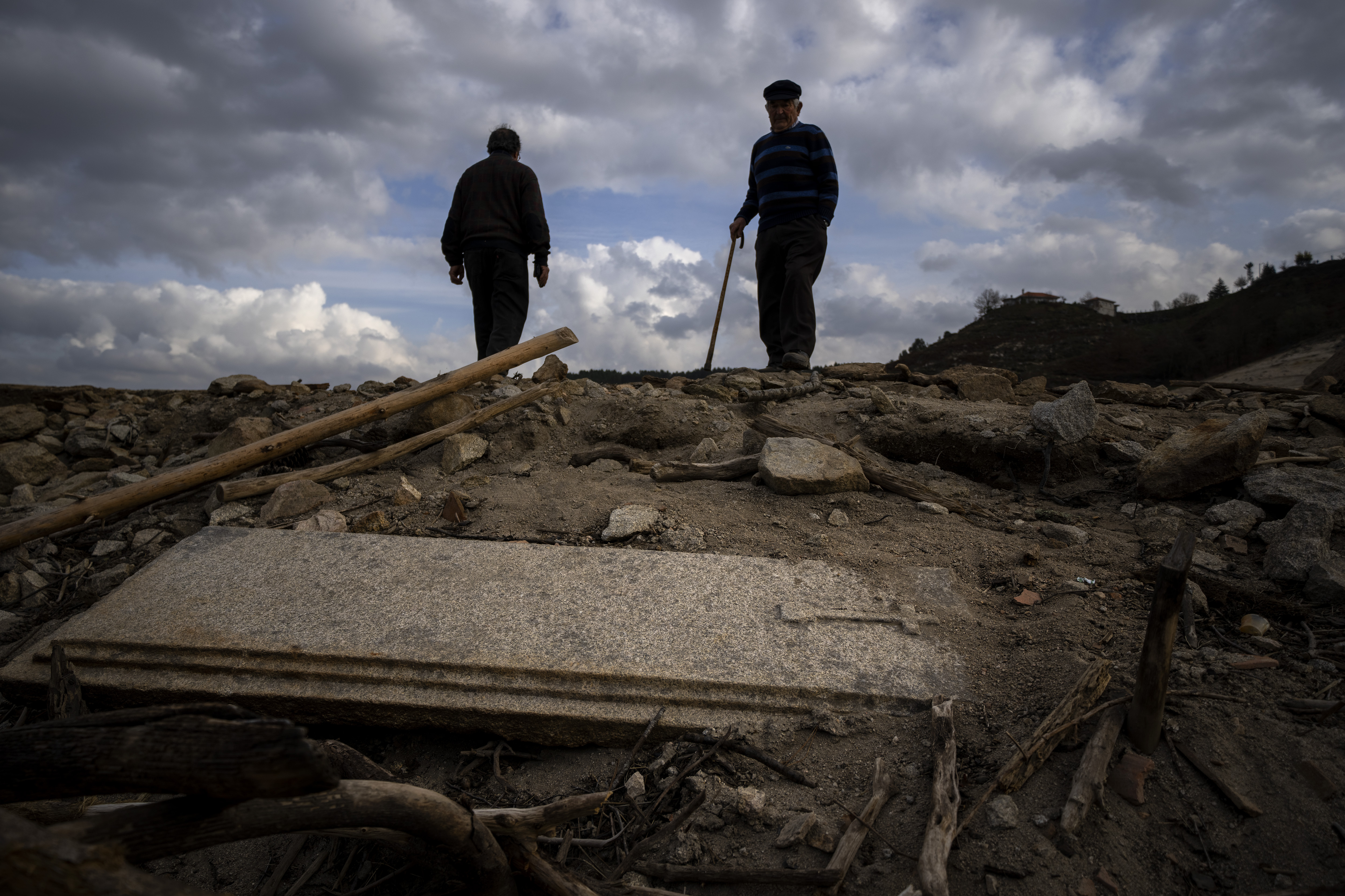 Julio Penin, 78, looks at a grave as they visit the old village of Aceredo