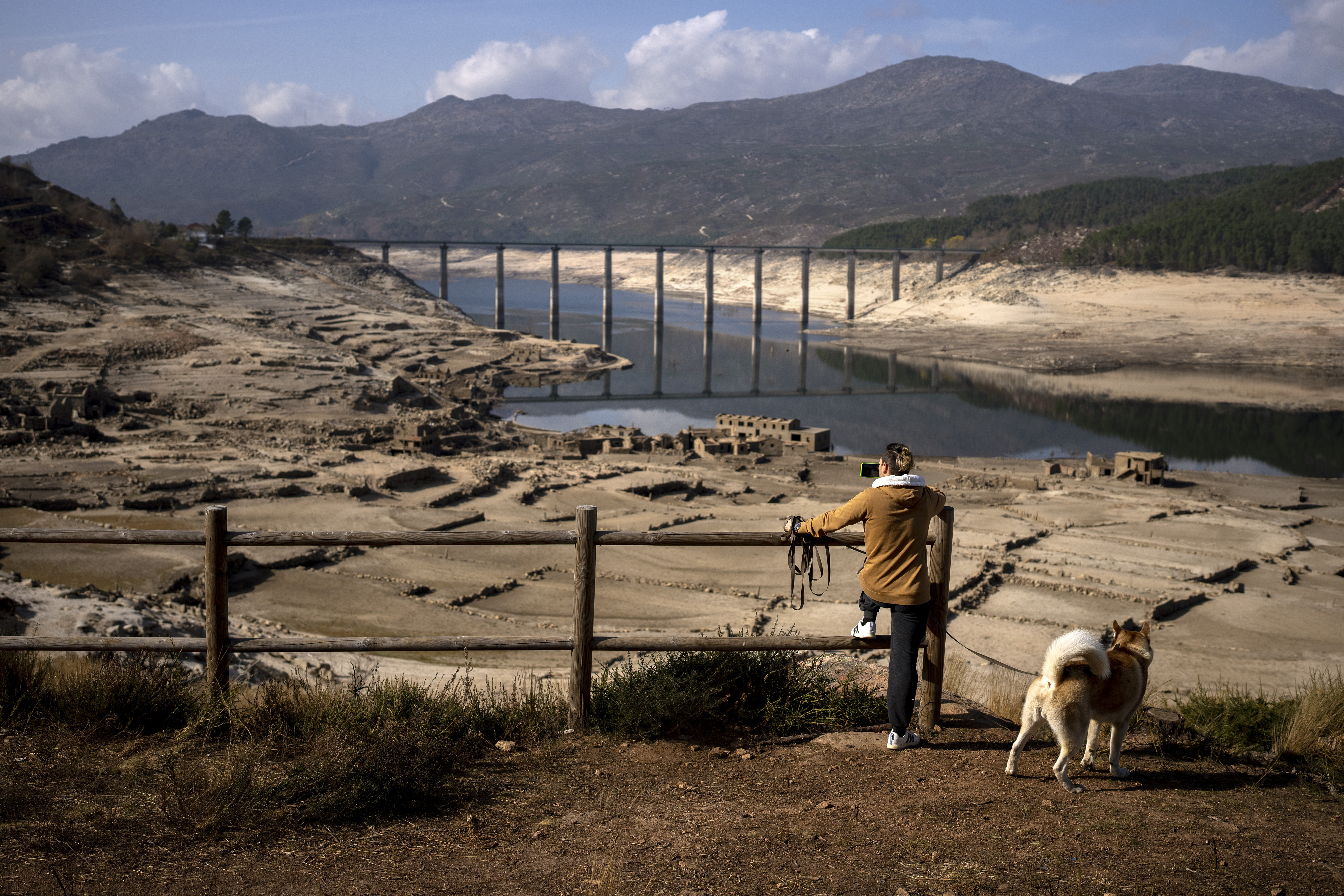 A man photographs the old village of Aceredo