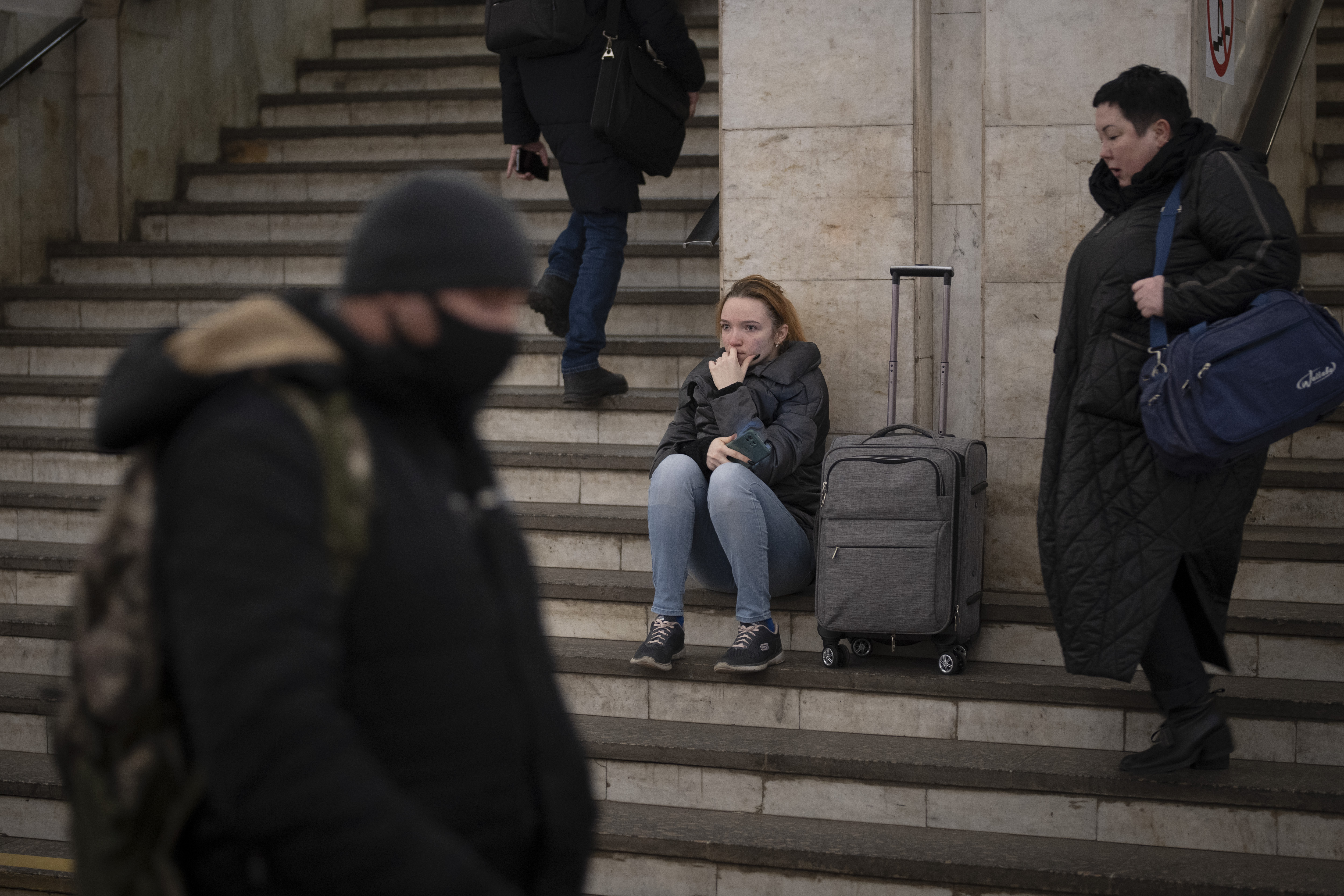 People walk in a subway to get a train as they leave the city of Kyiv