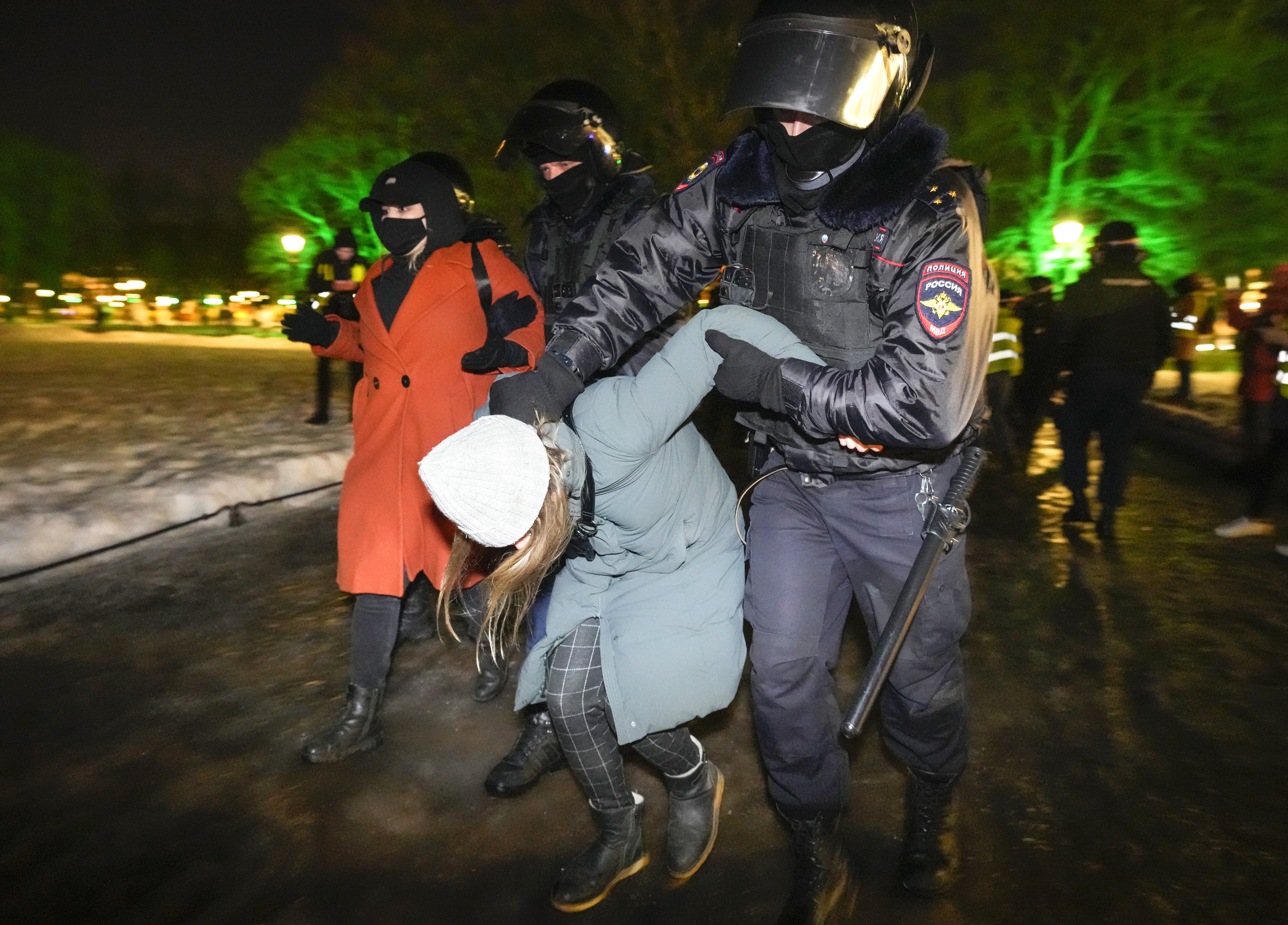 Police arrest a woman protester in Russia
