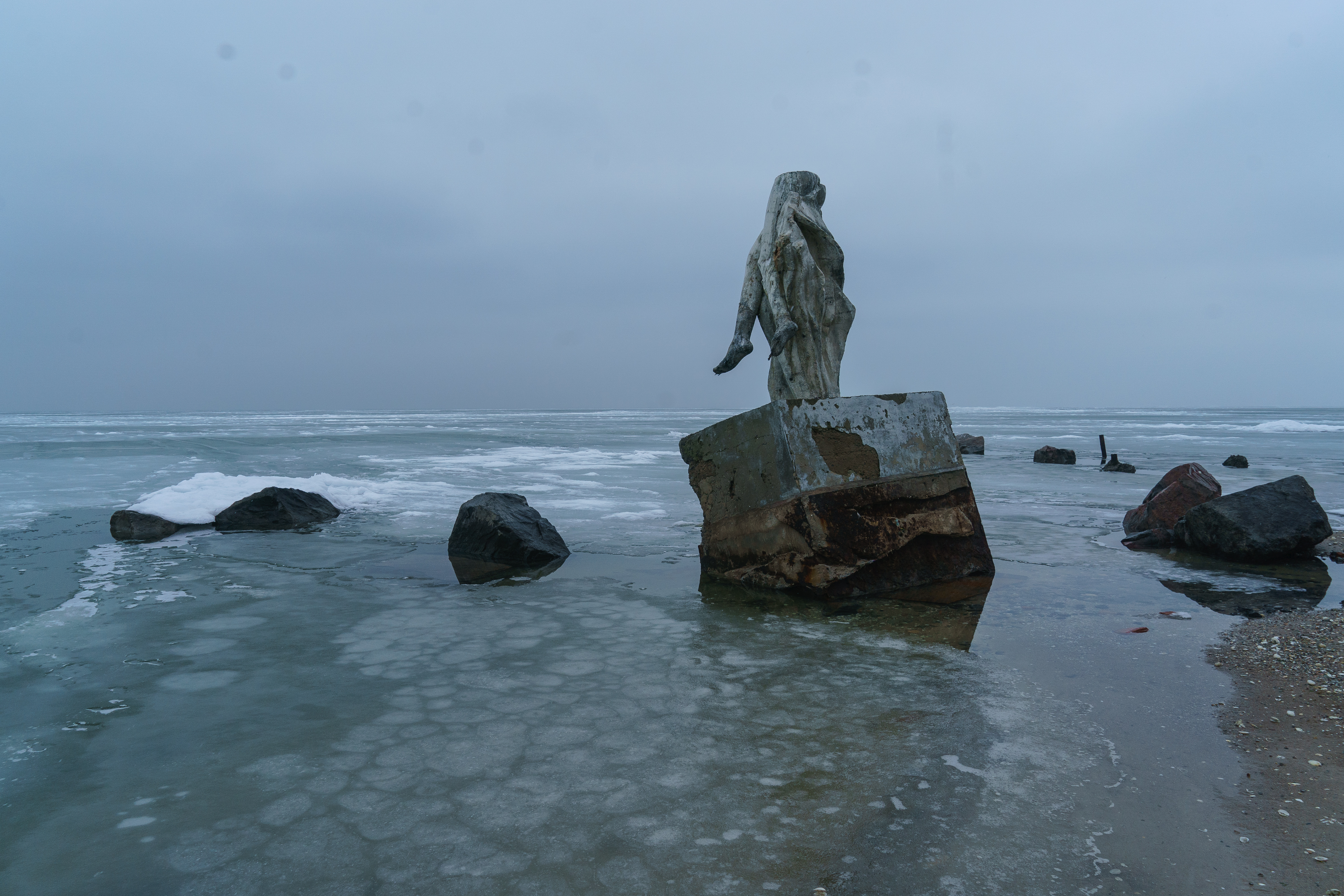 a broken statute in the abondaned village outskirts of Mariupol, Ukraine 2022.