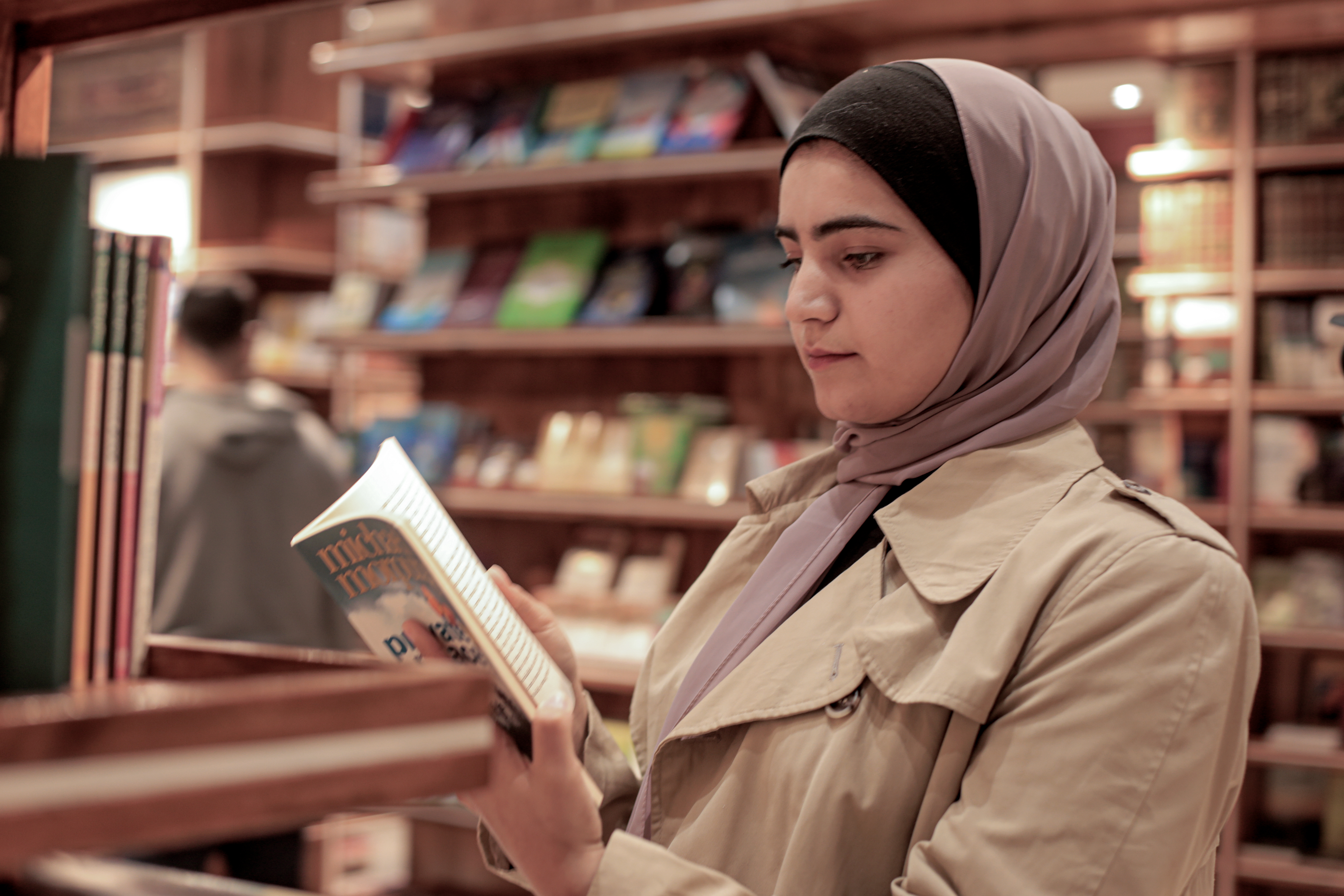 A young woman reads through a book