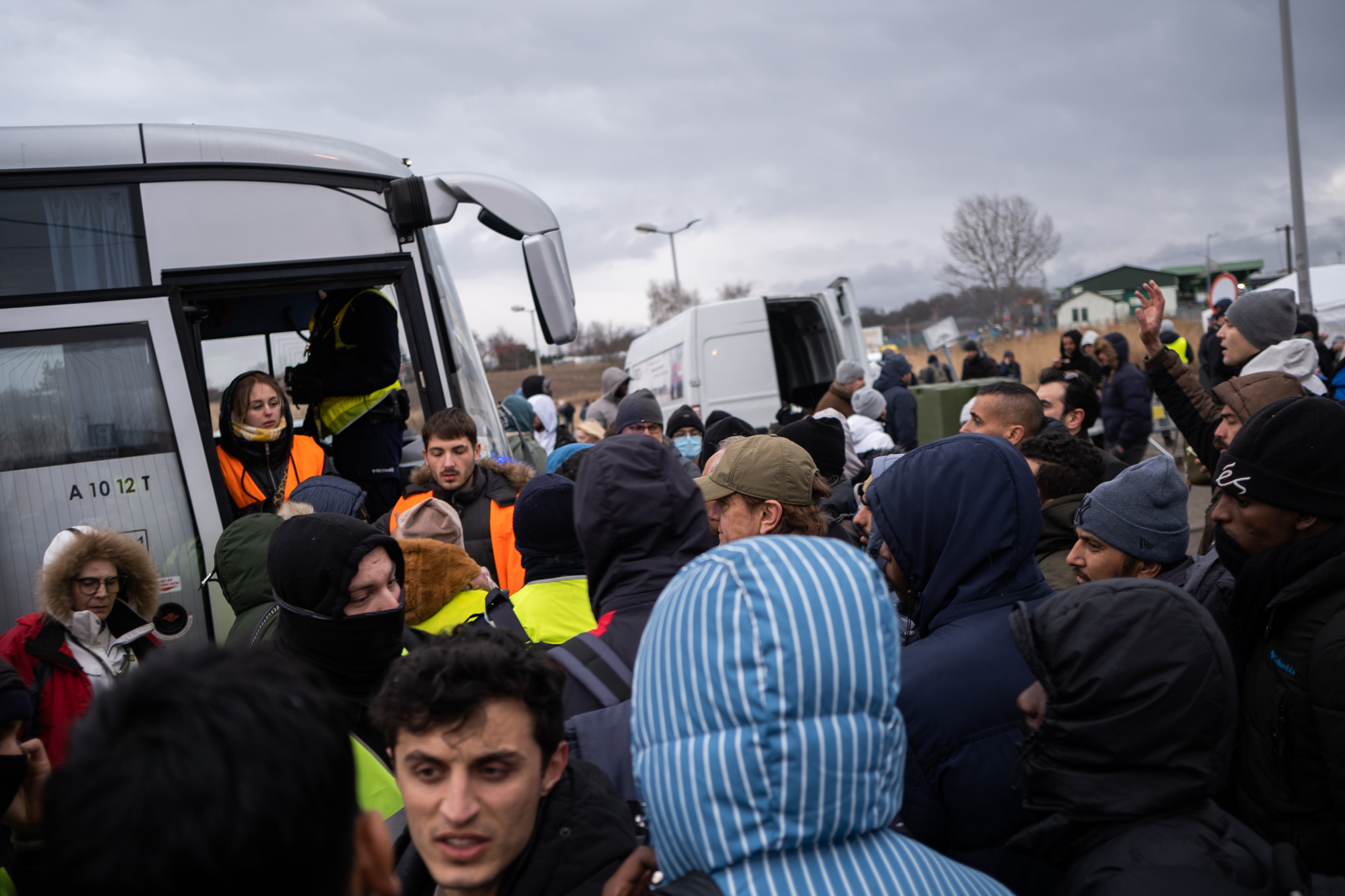 People who have fled Ukraine cram onto transportation which will take them to temporary accommodation.