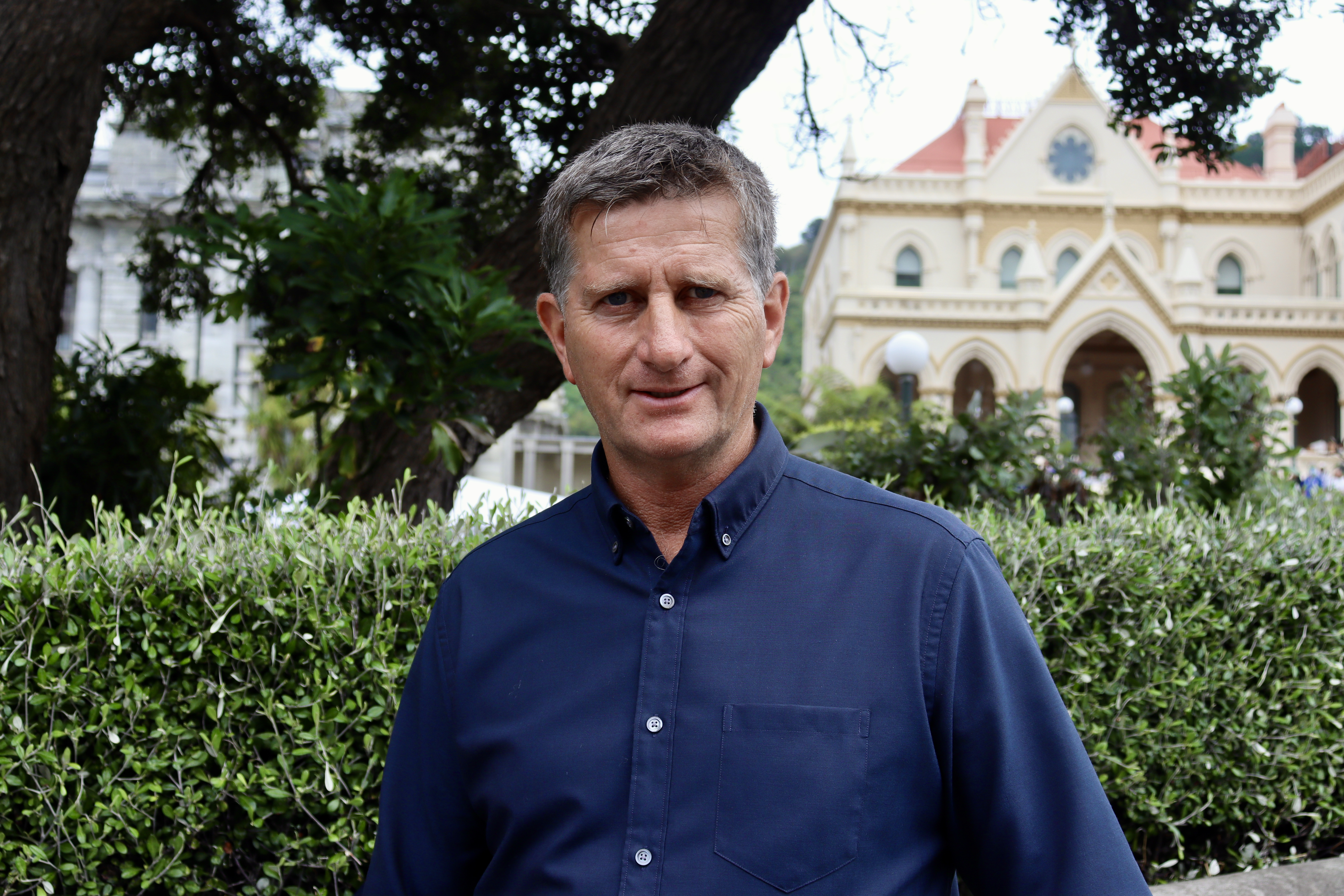 Leighton Baker in dark blue shirt and with greying hair is one of the protesters