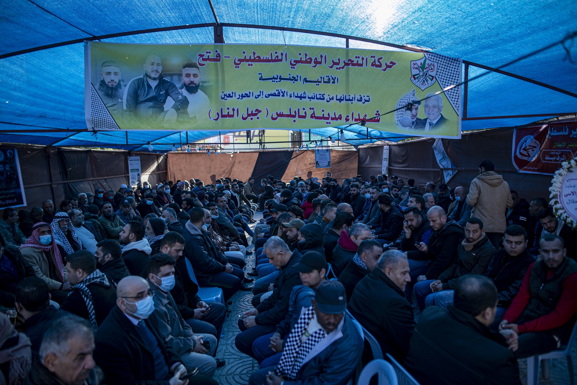 Palestinins sit a mourning tent after the march.