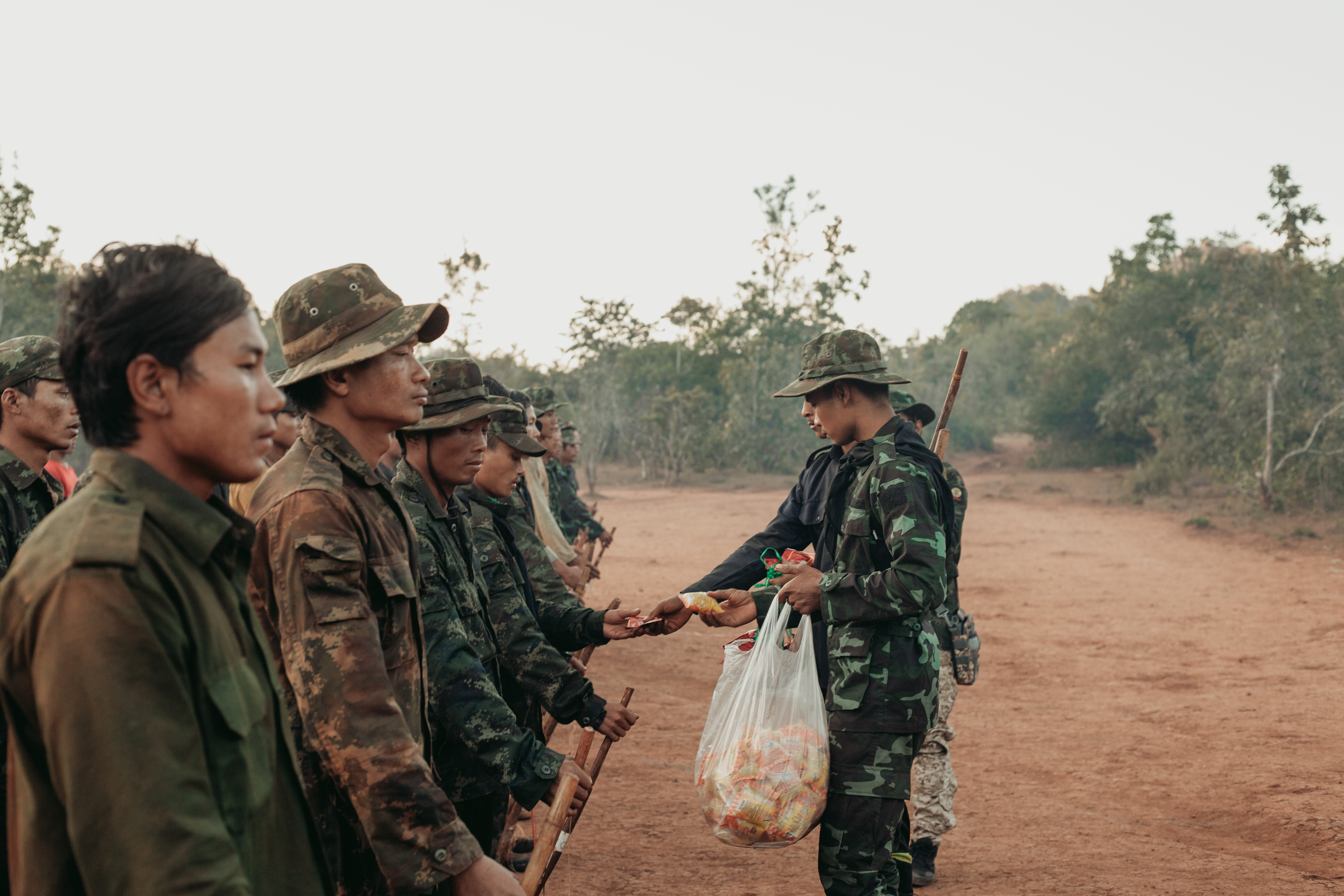 KNDF cadets receive small packages of food before embarking on a training mission.