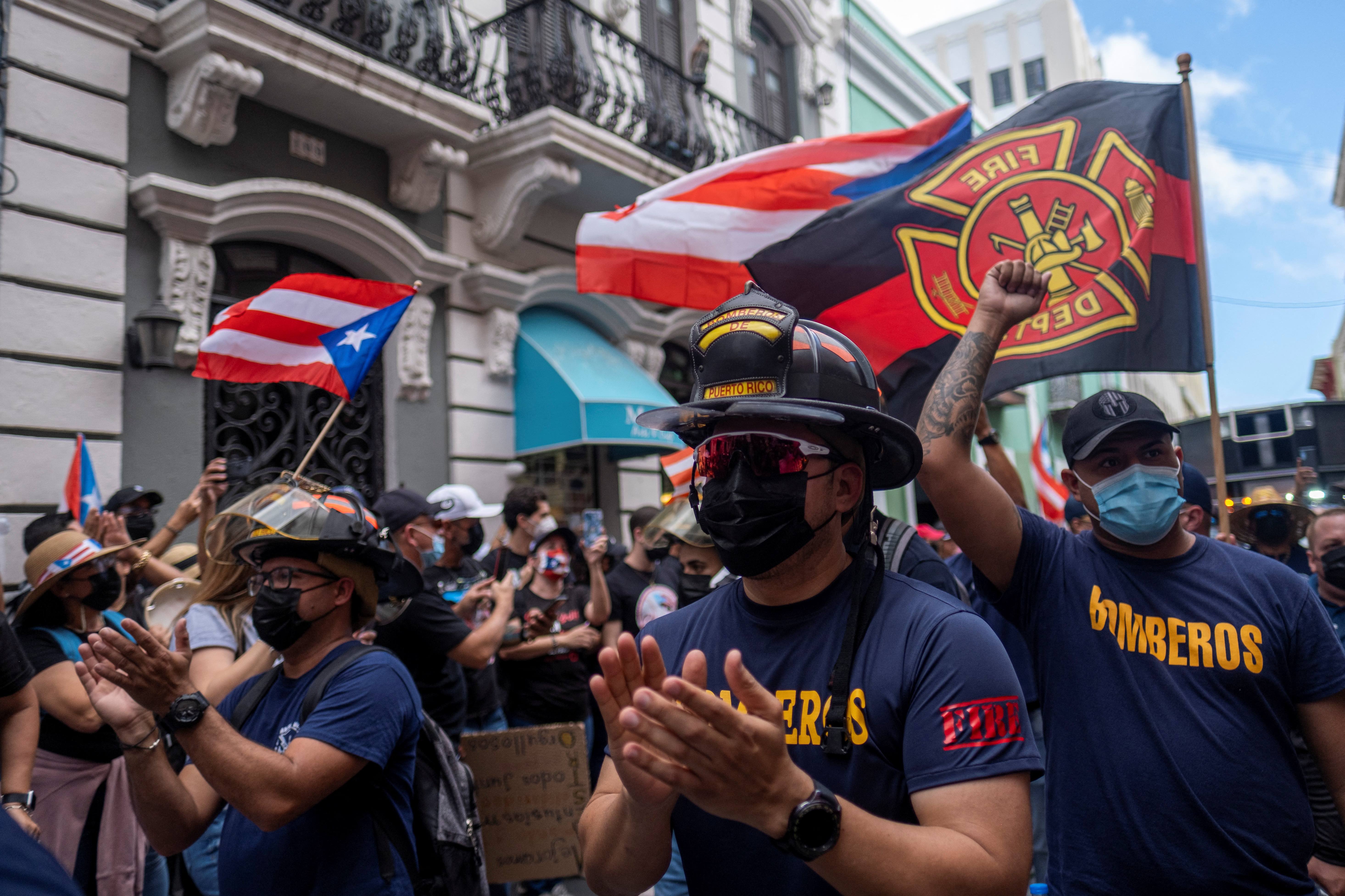 Puerto Rican firefighters participate in a march through the streets of Old San Juan