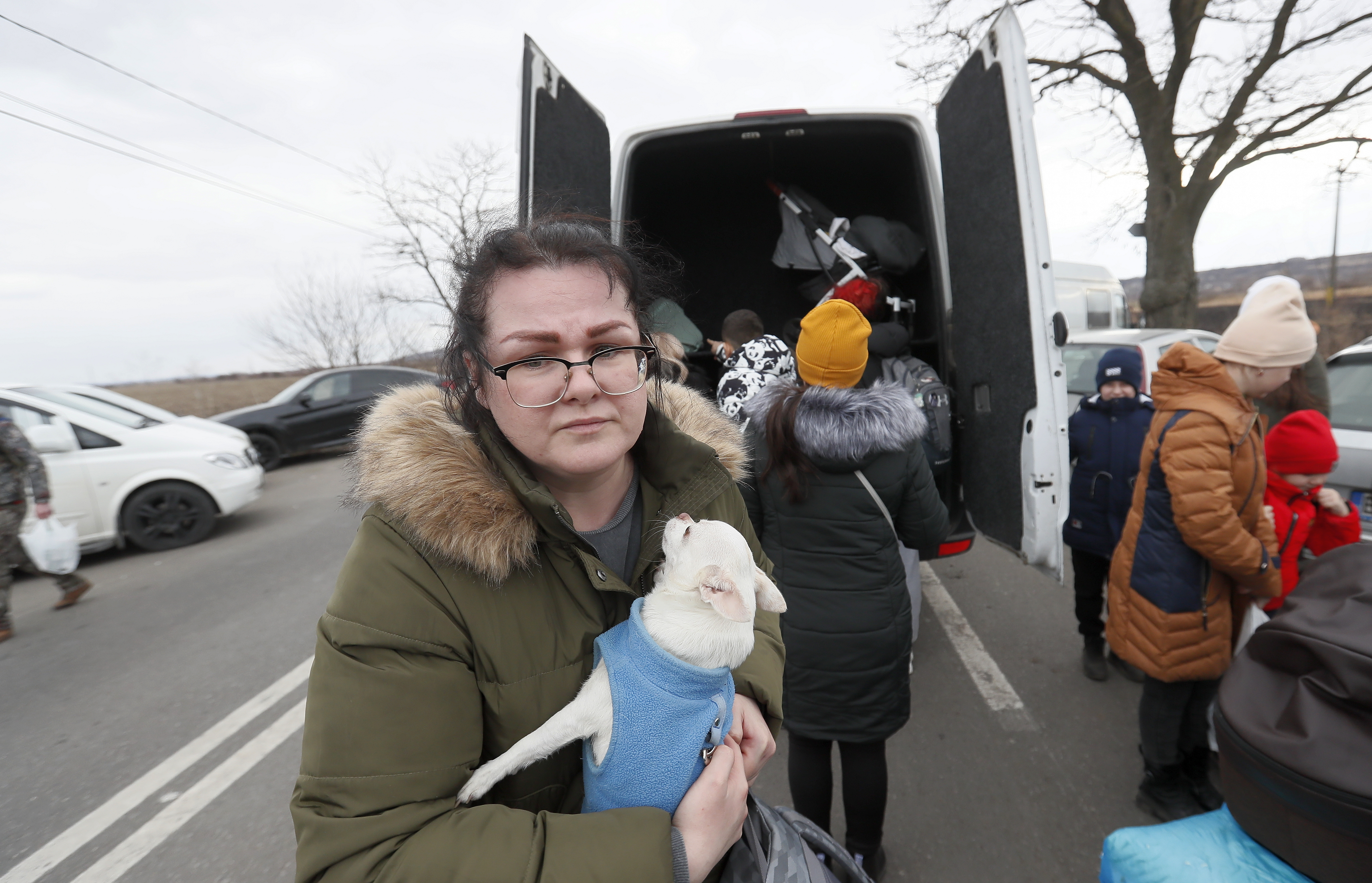 A Ukrainian refugee woman holds her pet