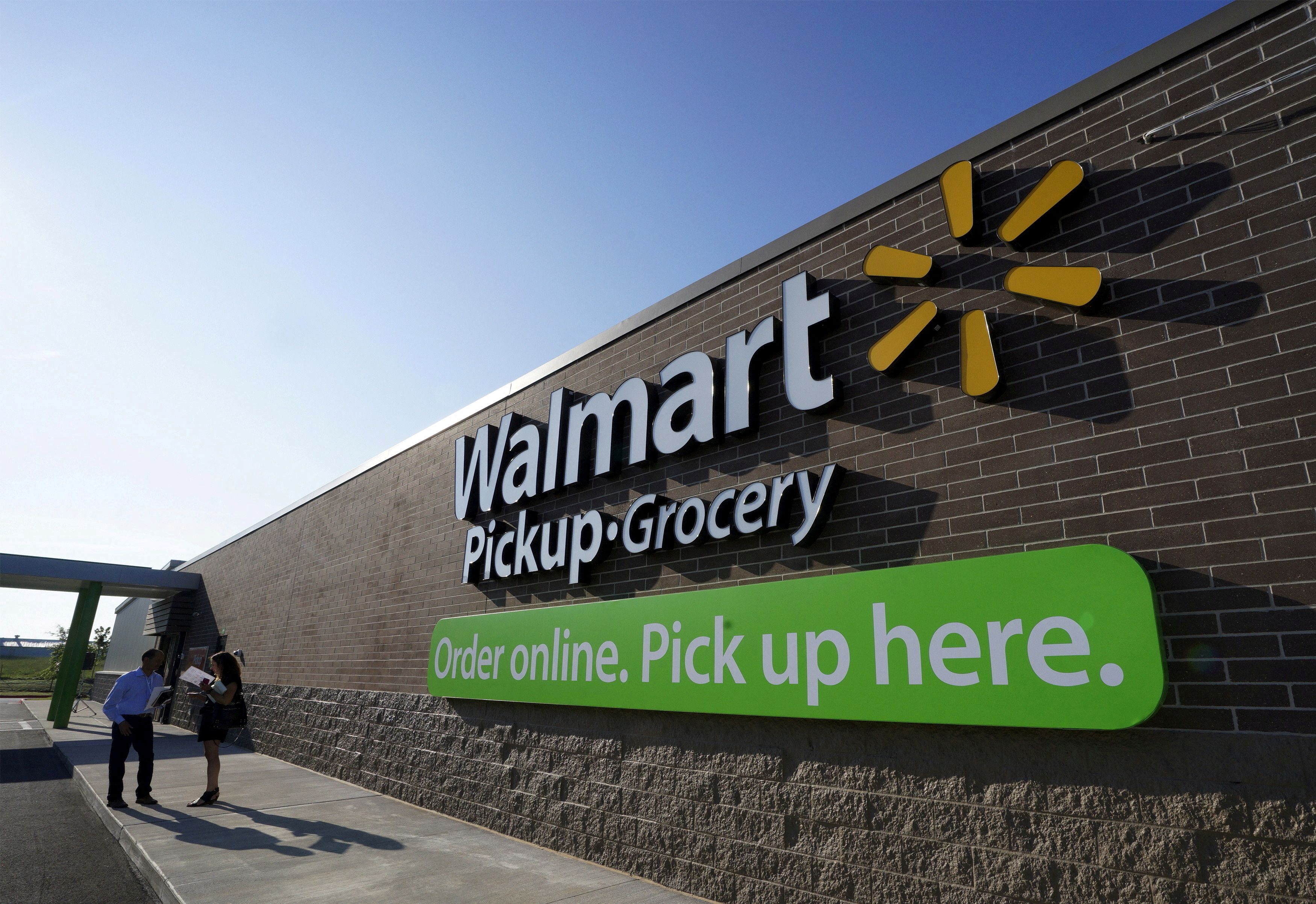 People talk outside a Walmart Pickup-Grocery test store in Bentonville, Arkansas