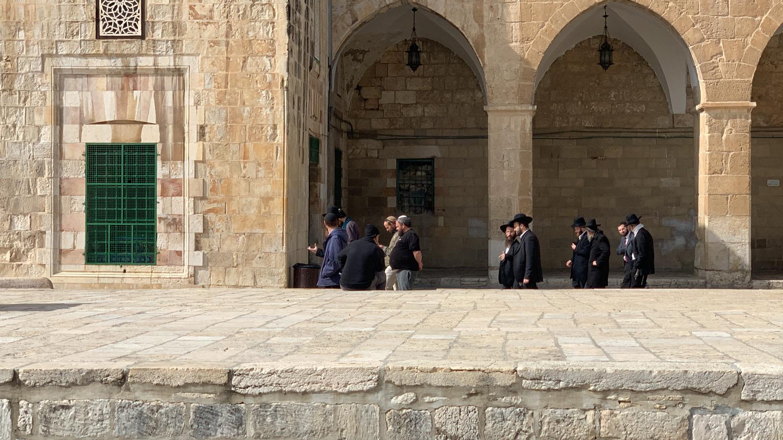 Israeli settlers walk around Al-Aqsa Mosque compound.