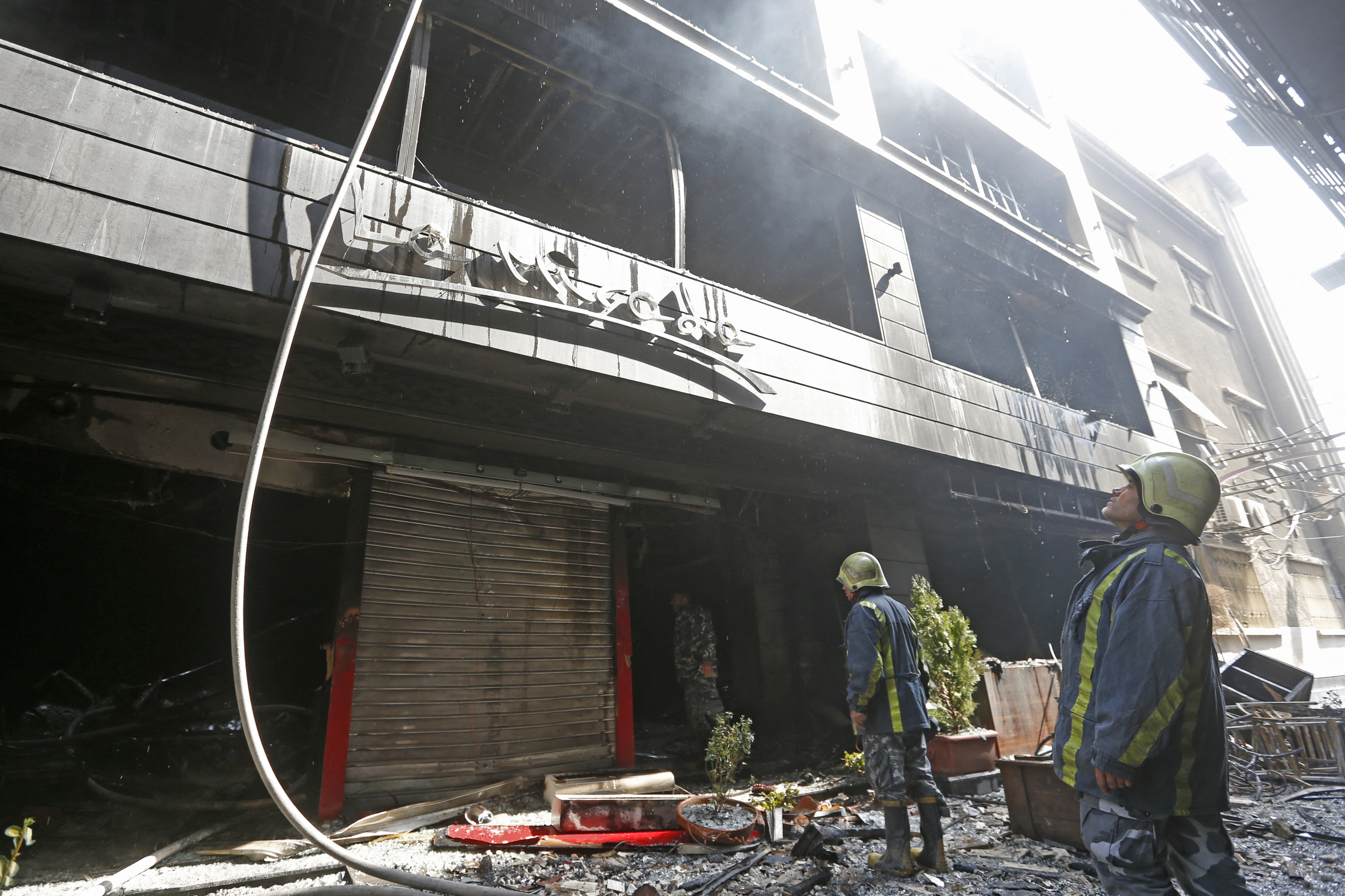 Firefighters extinguish a blaze that broke out at the La Mirada Mall in Damascus