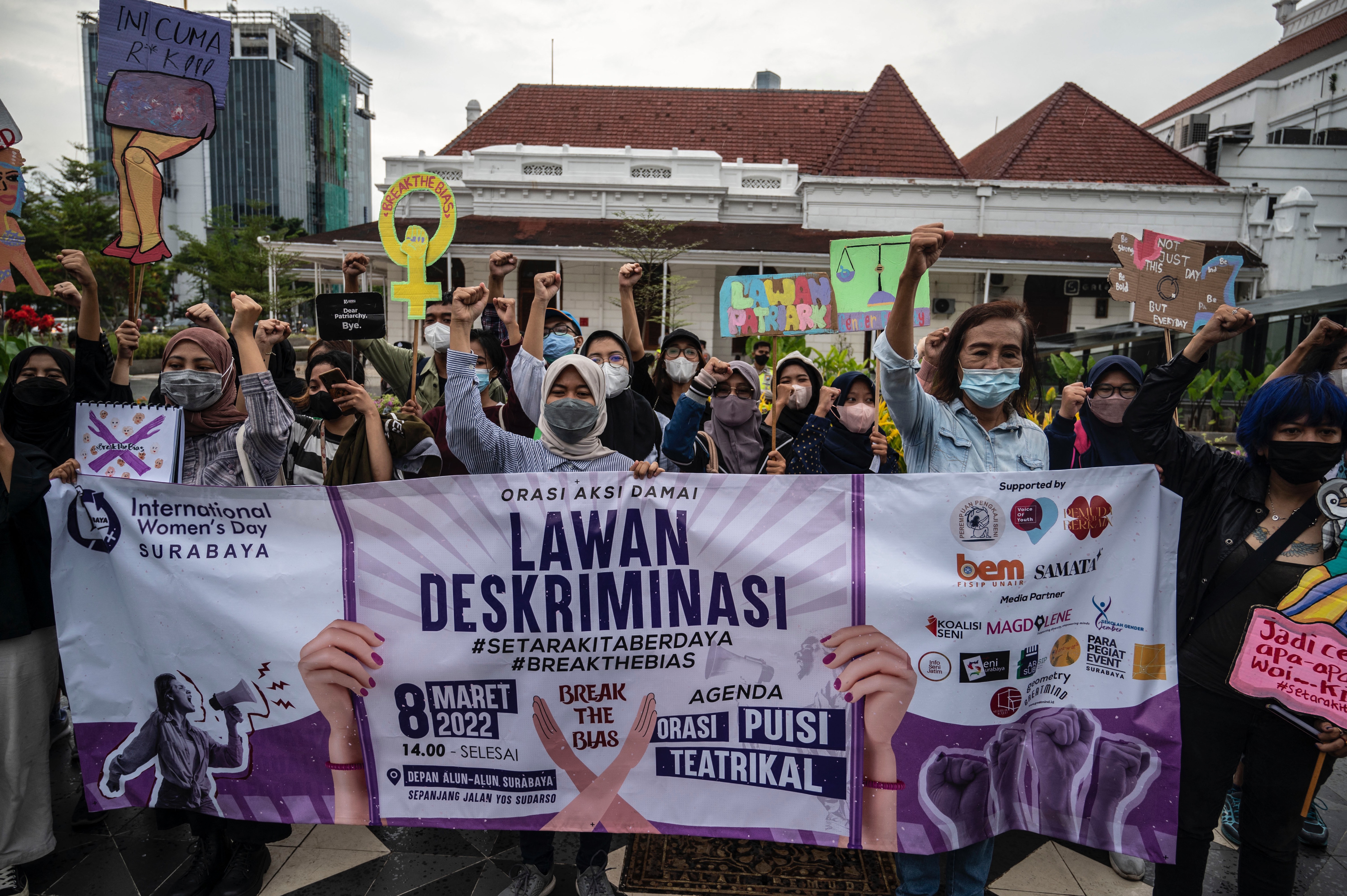 Activists take part in a demonstration for better women's rights on International Womens Day in Surabaya