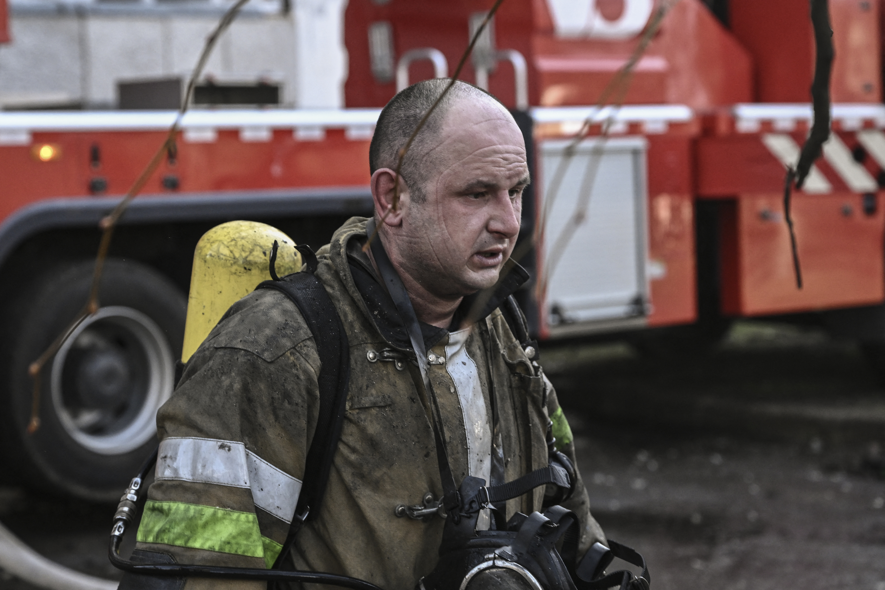 A fireman reacts outside a burning apartment building in Kyiv