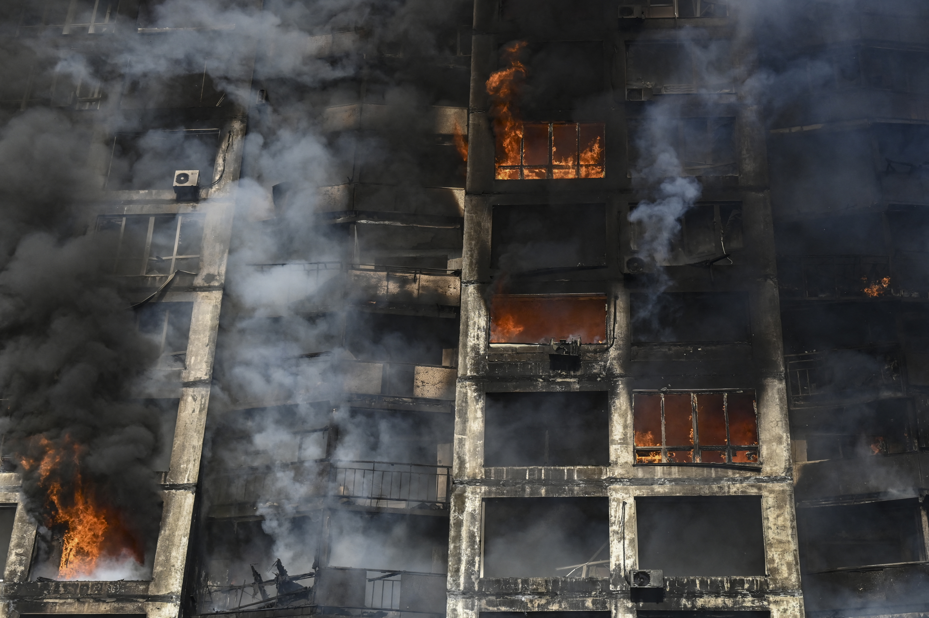 Firefighters extinguish a fire in an apartment building in Kyiv on March
