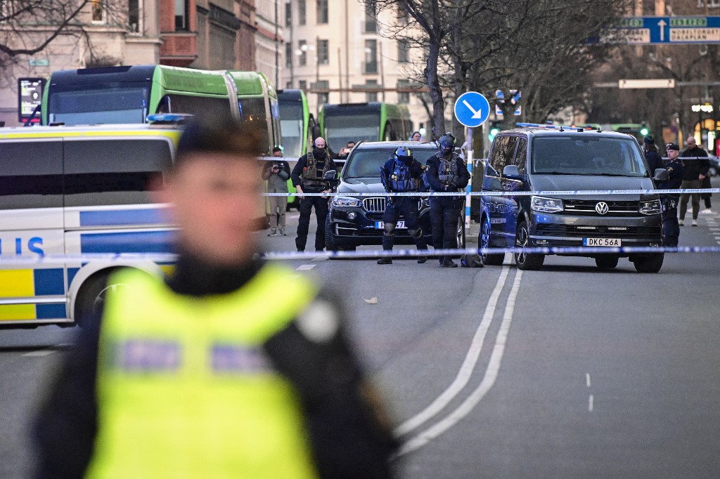 Police commandos gear-up as they arrive at the scene of a reported incident at the Latin School in Malmo