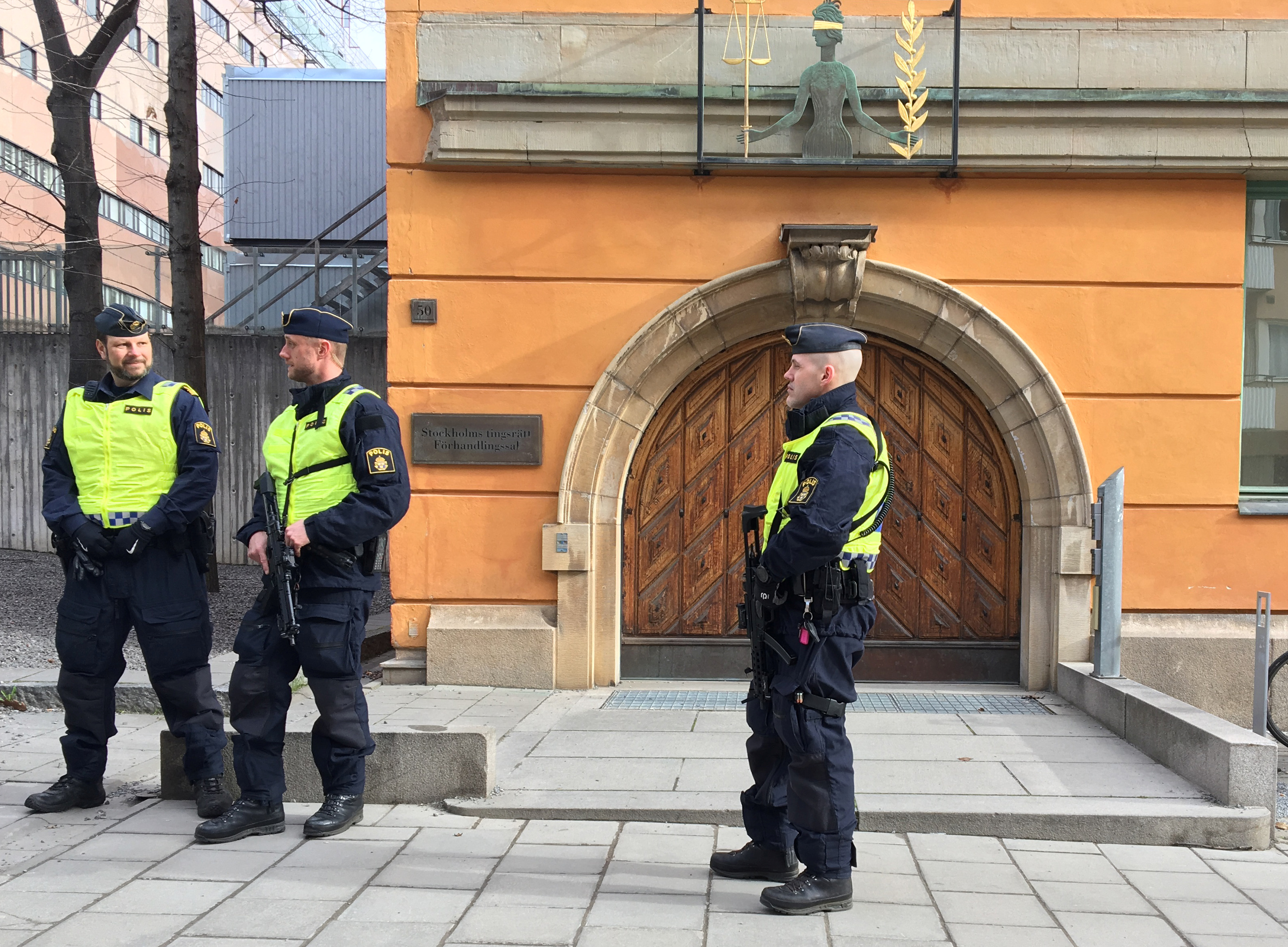 Police stand at Stockholm's district court building