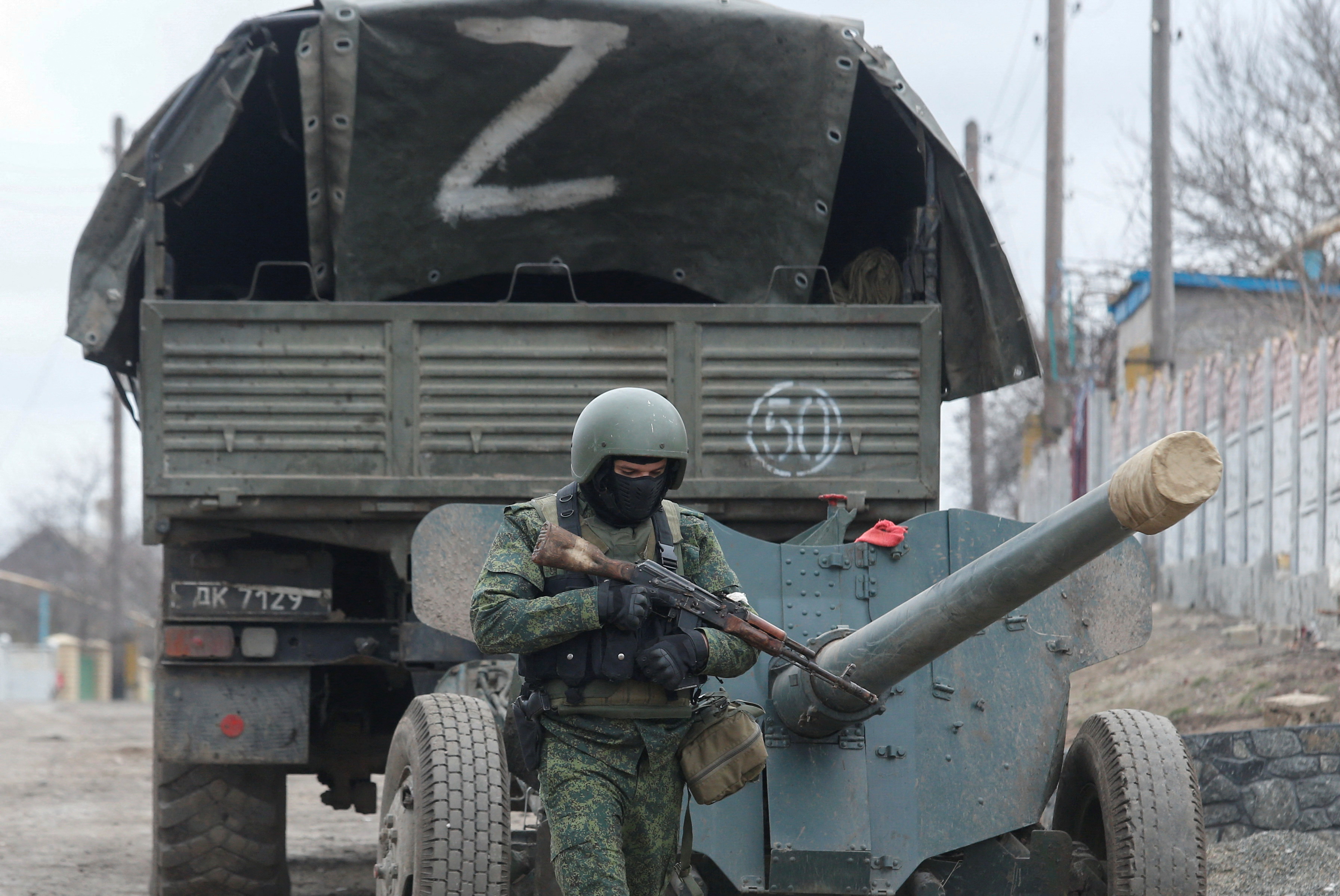 A service member of pro-Russian troops in a uniform without insignia walks past a truck with the letter "Z" painted on its tent top in the separatist-controlled settlement of Buhas (Bugas), as Russia's invasion of Ukraine continues, in the Donetsk region, Ukraine March 1, 2022.
