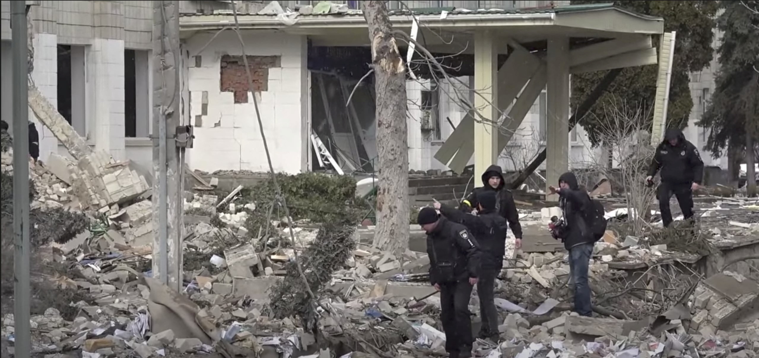 Residents in Zhytomyr look through the rubble. 