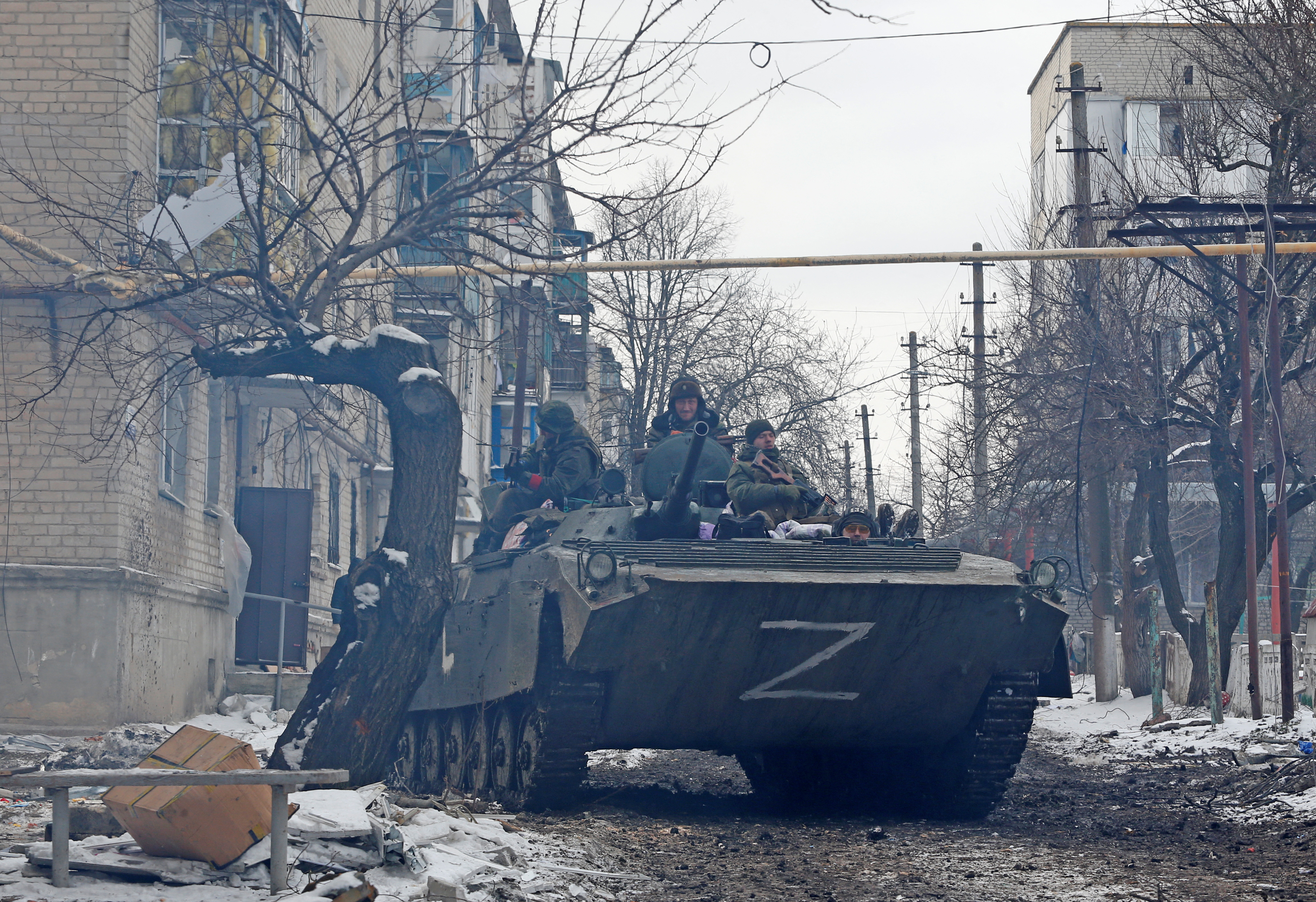 Service members of pro-Russian troops in uniforms without insignia drive an armoured vehicle with the letters "Z" painted on it in a residential area of the separatist-controlled town of Volnovakha during Ukraine-Russia conflict in the Donetsk region, Ukraine March 11, 2022
